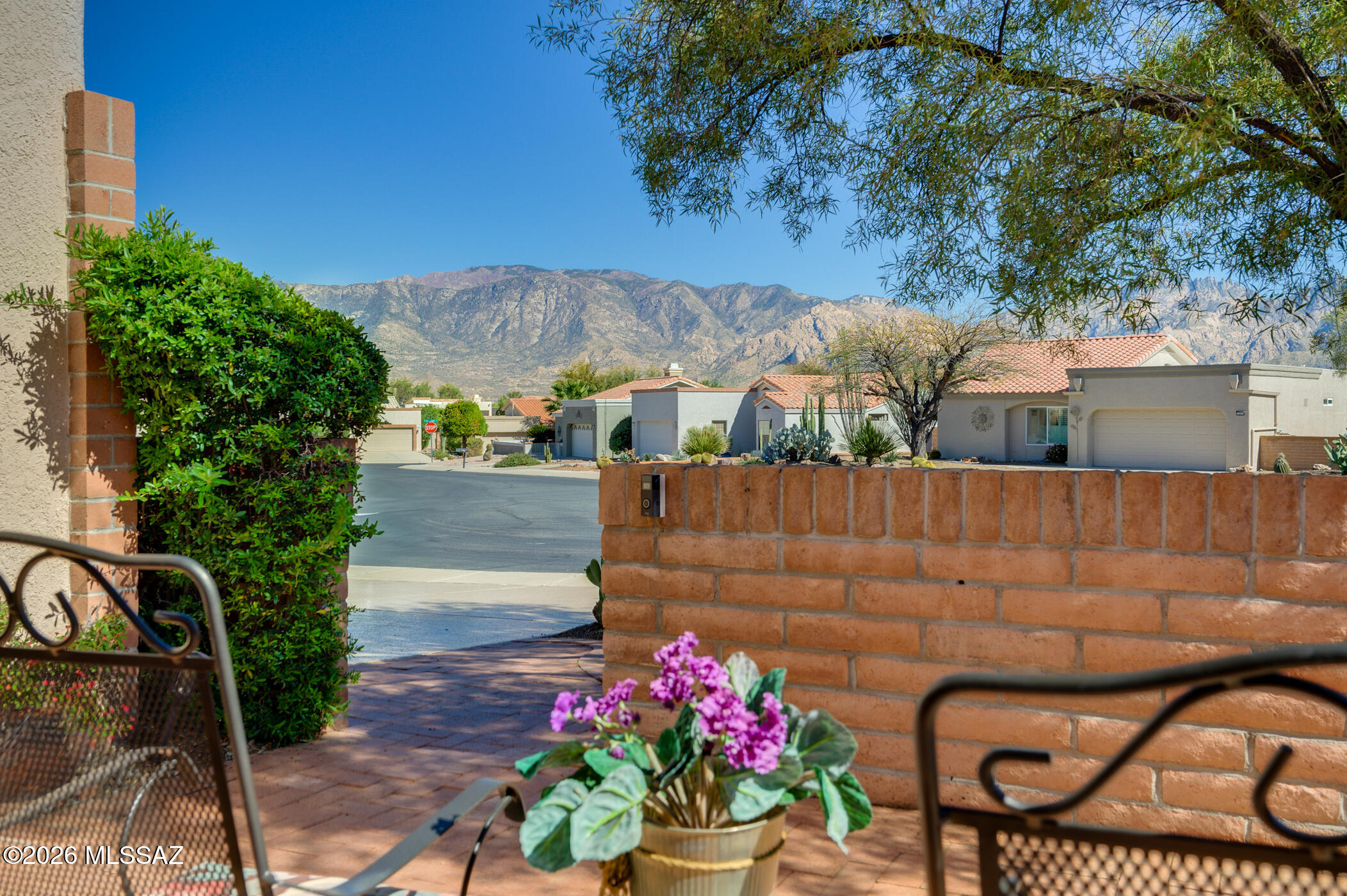 Are you ready to being your active adult lifestyle in Sun City Oro Valley?  If so, don't miss this well-kept, expanded Deerfield Model home which is situated on a quiet cul-de-sac lot & boasts expansive Catalina Mountain views from the welcoming front courtyard. The fully fenced backyard also offers mountain viewing spaces & numerous seating areas for relaxing & easy entertaining. You'll love the private courtyard behind the front security-screened door, too. Upon entering, pretty plank tile flooring welcomes you into the living & dining rooms. The sliding door to the back patio area opens to a patio space highlighted by electric screens which open and close - adding open-aired living space & privacy to the home. The spacious, light-filled Chef's kitchen has a gas cooktop, wall oven, built-in desk & plenty of cabinets & counter space. A cozy nook with bay window & an added family room with a sliding door to the back patio add extra charm to this home. A small bonus room, with garage access, is just off the kitchen. The primary bedroom has been freshly painted, has plantation shutters, a lovely bay window with peaceful backyard views & a large en-suite bath showcasing dual vanities, a walk-in shower, granite countertops & a walk-in closet. The guest bedroom, complete with a Murphy Bed, is located in a separate wing for added privacy. The 2nd bath is next to the guest bedroom and has easy access from the rest of the house. This quiet corner lot offers easy-care landscaping & mature fruit trees, several patio areas, 2 screened-in spaces & beautiful mountain views. Sun City Oro Valley is a premier active adult community nestled in beautiful Oro Valley, Arizona. Don't miss your opportunity to own this special home!