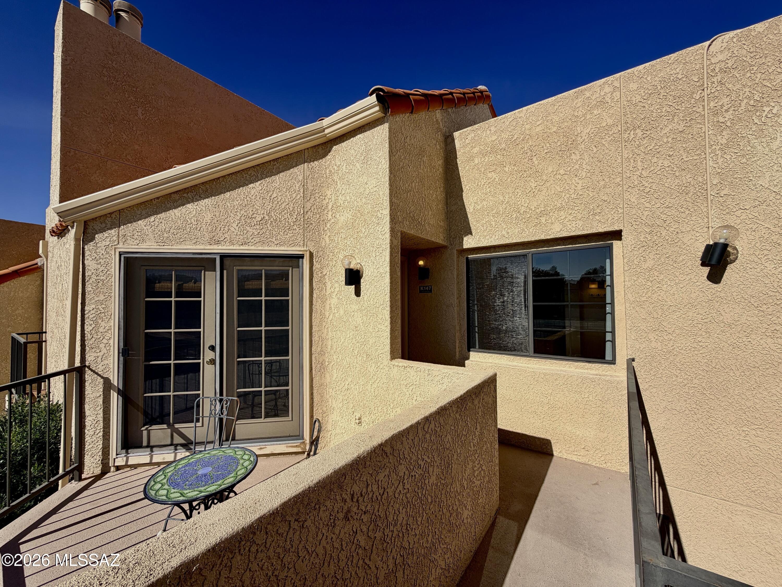 Convenient Northside location! This 2bdr/2ba upstairs condo has a great split bedroom floor plan both w/private baths. High ceilings with tons of natural light from clerestory windows & patio French doors make this home feel very spacious. Enjoy mountain views from two patios. Bathrooms w/skylights & primary boasts walk-in shower, second bath features double sinks & tub/shower combo. Open great room w/vaulted ceiling, ceiling fans in primary BR and living room, new AC in 2022, washer/dryer & stainless appliances. Additional storage area off primary BR deck.  One covered parking space & ample unassigned parking in front. Community offers, pool, spa, and fitness center. Minutes to Rillito Riverwalk, Trader Joes, St. Philips Plaza & more! Fireplace equipped w/remote operated candelabra.
