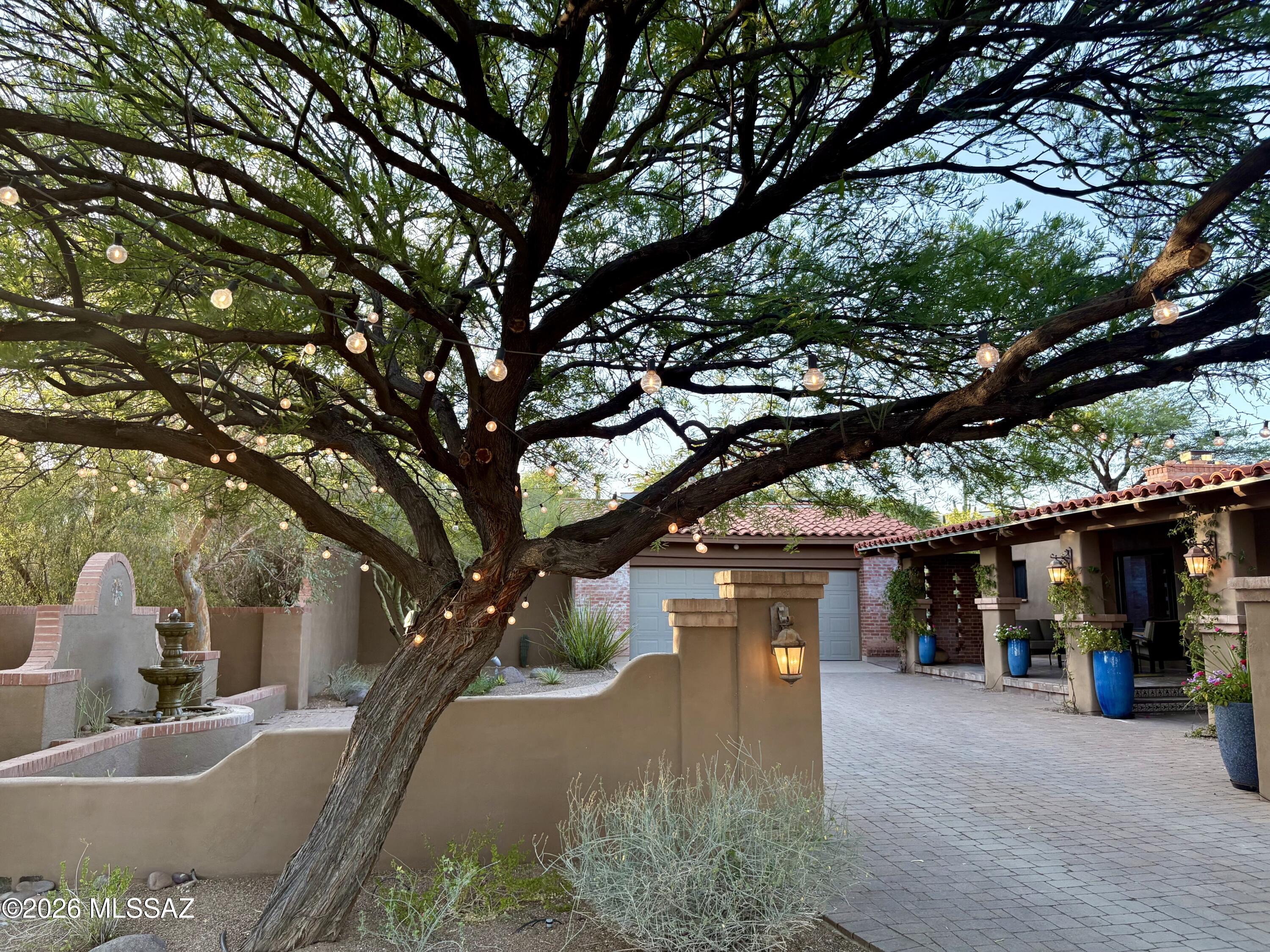 Tucked into the historic neighborhood of Catalina Foothills Estates is this serene Hacienda style home w/high exposed wood beamed ceilings, decorative doorways, modern concrete floors throughout, remodeled chefs kitchen w/butlers pantry, ample outdoor entertaining areas & so much more. This home is a blend of views, nature, comfortable luxury living, natural light & an outdoor paradise.  Enter through a courtyard w/fountain at the entrance, onto a front veranda into the home where you'll find high wood beamed ceilings, fireplace and large living/dining room.  Kitchen is open w/high ceilings, huge island, 2 sinks, gas range, subzero fridge, overlooking the family room/fireplace & adjacent to the butlers pantry w/additional dishwasher, beverage drawer & 100 bottle wine fridge. Primary Suite w/fireplace, huge walk in closet, bathroom has dual sinks, jetted tub & separate shower w/steam shower feature. Outside beautiful pebble tec pool w/natural stone & pavers surround, gas fire-pit, artificial turf, Sport Court for basketball / pickle ball, a Casita w/bathroom for guest use or gym, numerous outdoor entertaining areas w/Mountain Views & 2 car detached garage features an electric car charger & storage.  This property has sought after Catalina Foothills Schools, close to hiking trails, biking, premier shopping, restaurants, & just 15 mins to downtown & UA. This home truly has it all