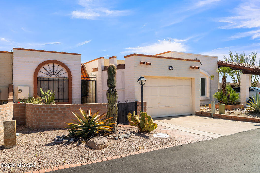 Comfortable 2-bedroom, 2-bath townhome in the popular retirement community of Green Valley. This well-maintained home features a tastefully updated kitchen and baths, a nice-sized pantry, and a cozy wood-burning beehive fireplace. Enjoy the screened Arizona room along with both front and back patios for relaxing outdoors. The backyard includes a beautiful fountain and a prolific orange tree. Additional features include a one-car garage with a storage closet, providing extra space for tools, hobbies, or seasonal items. A wonderful opportunity to enjoy easy, low-maintenance living.