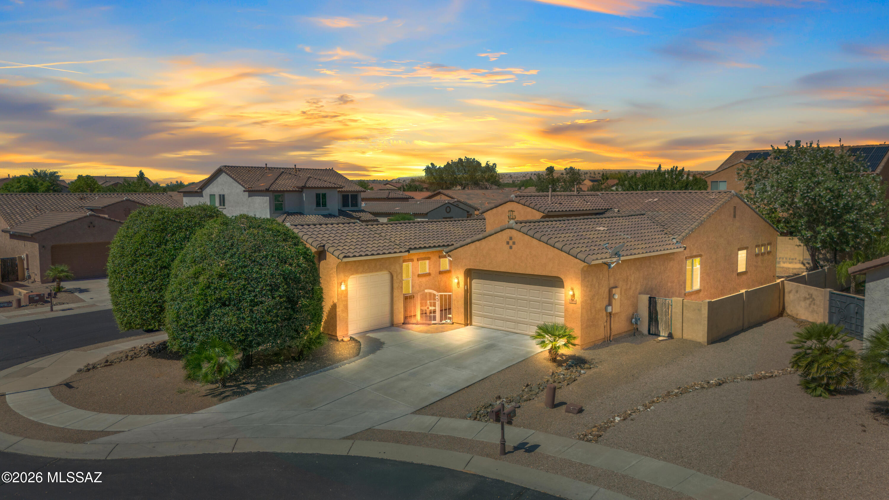 Situated in a private gated subdivision and in a cul-de-sac, this spacious 3 car garage home welcomes with a private gated court yard. Step inside to a welcoming formal dining room, 3 bedrooms, a den and a well-appointed hall bathroom with a tub/shower combination. The primary suite offers a luxurious retreat with dual sinks, a walk-in shower, a soaking tub and a large walk in closet conveniently connected to the laundry room. This home is designed for both everyday living and entertaining. This  home offers a generous family room and an upgraded kitchen featuring: double ovens, cooktop stove, large kitchen island, walk-in pantry and an abundant cabinetry and storage space.  Step outside to enjoy the paver backyard and covered patio, perfect for relaxing or hosting guests. Additional highlights include: Water softener,  close to Anza Trail K-8 School, parks, Rancho Sahuarita Club House, Sahuarita Lake, shopping, dining and I-19.  This home combines comfort, functionality, and desirable amenities in an exceptional location.