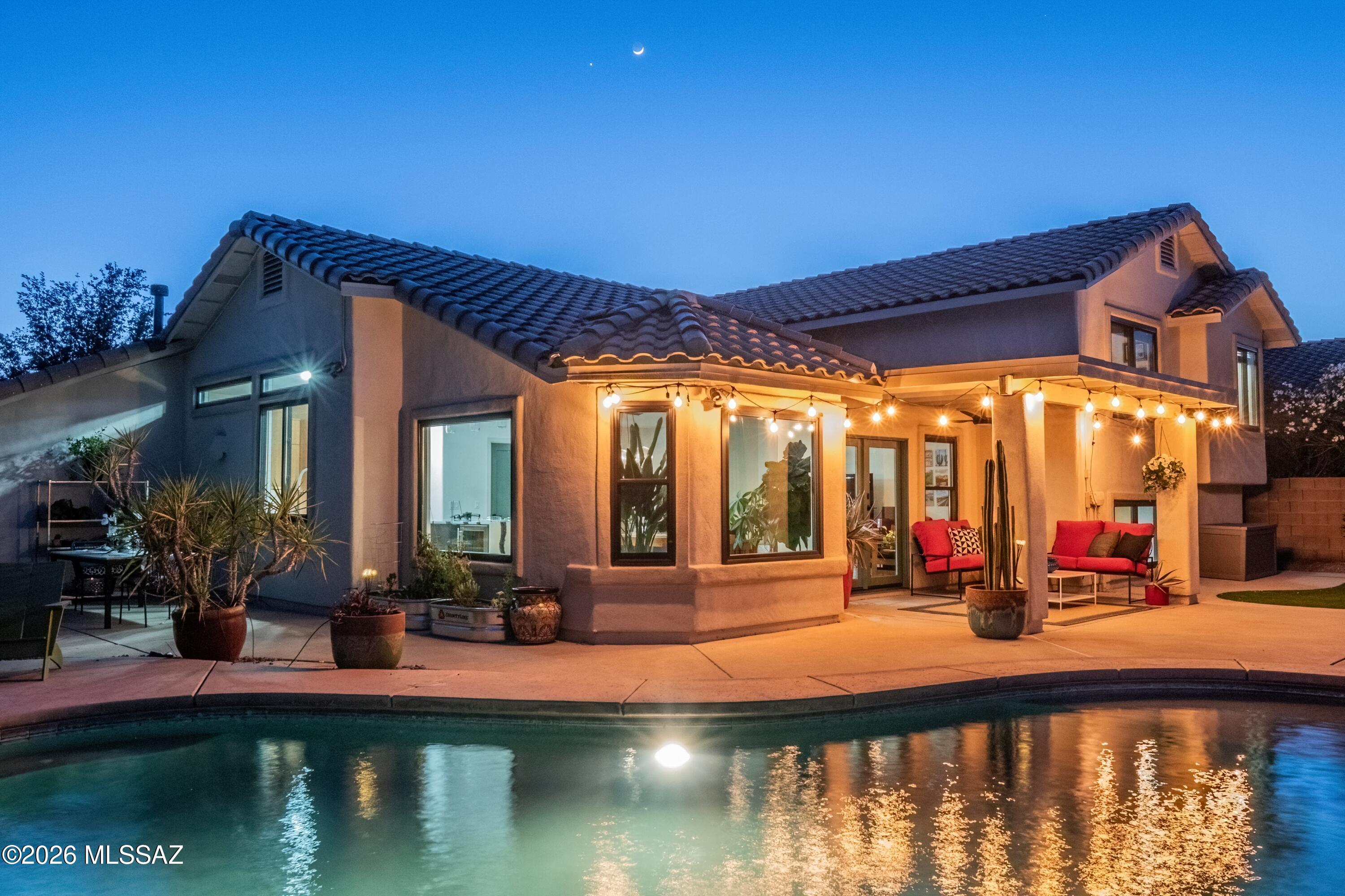 Experience elevated desert lifestyle living in this immaculate, completely remodeled Oro Valley retreat set on a premium lot with breathtaking mountain views, sparkling city lights, and exceptional privacy. With no rear neighbors and only one side neighbor, this stunning 5-bedroom, 3-bath home offers the perfect blend of luxury, comfort, and serene desert beauty. Designed for both everyday living and entertaining, the spacious open-concept great room flows seamlessly into a spectacular fully remodeled kitchen featuring custom cabinetry, quartz countertops, a massive waterfall island, and premium stainless-steel Wolf appliances. Expansive windows showcase the surrounding mountain views while filling the home with natural light. The luxurious primary suite offers a true retreat with panoramic mountain views and spa-like ambiance. Every detail throughout the home has been thoughtfully upgraded with no expense spared, including all new flooring, brand-new windows, new roof, fresh exterior paint, designer exterior lighting, and custom California Closets throughout. Come outside to your private backyard oasis complete with a refinished pool, tranquil water features, multiple seating and entertaining areas, new artificial turf, fresh landscaping, and newly updated decking all perfectly positioned to capture the stunning mountain backdrop and dazzling city lights at night. Additional features include a spacious 3-car garage, beautifully updated front and rear landscaping, and a highly sought-after heart of Oro Valley location close to dining, shopping, and recreation. Luxury, privacy, and unforgettable views, this exceptional desert estate truly has it all.