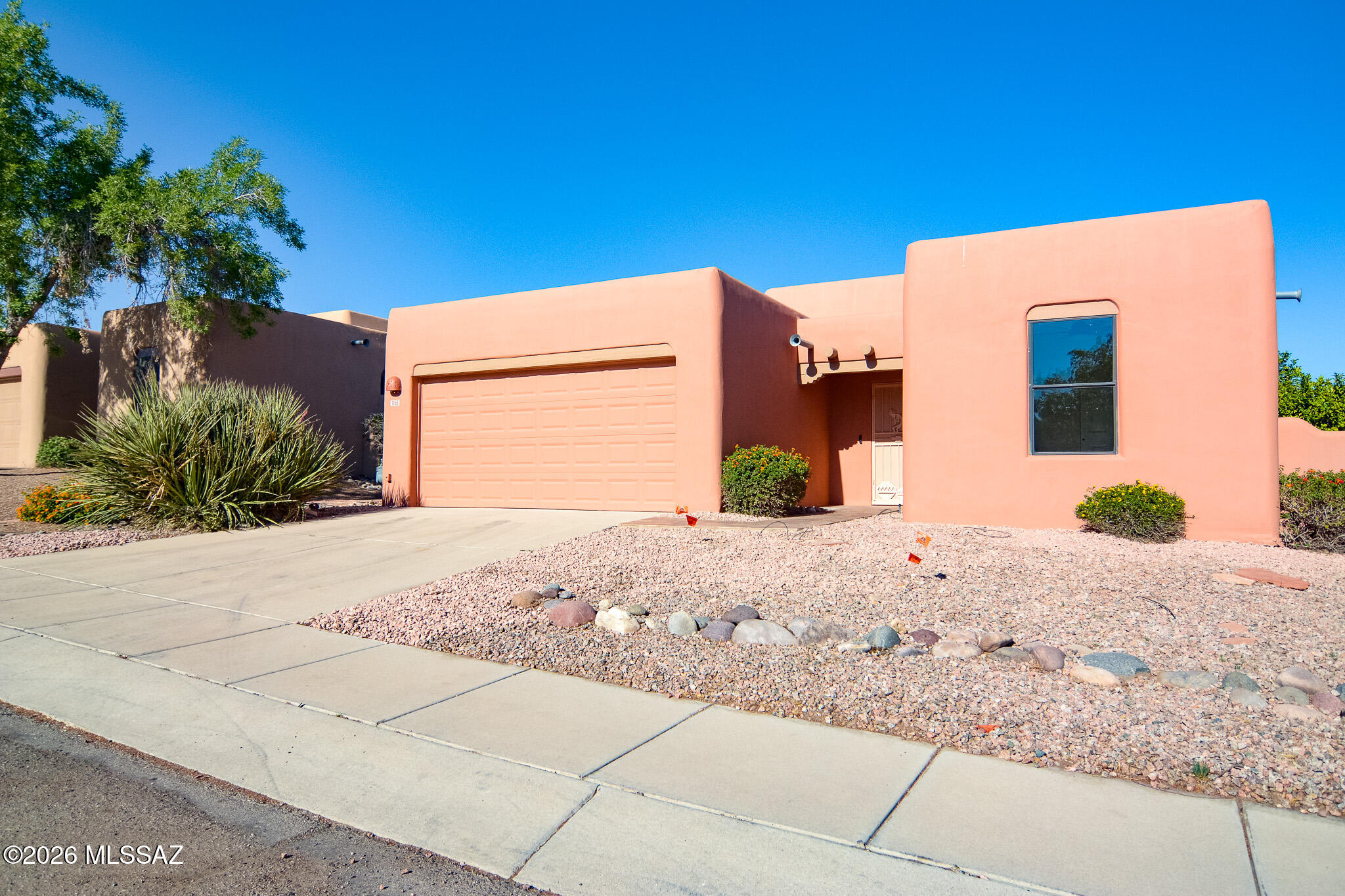 Beautifully remodeled santa fe style home. Located in a desirable Northwest Tucson location. Minutes from the I-10. Rustic saltillo tile. New carpet and padding in bedrooms. Beehive fireplace in living room. Contemporary kitchen with stainless steel appliances. New custom interior paint and exterior paint. Spacious owner's suite with a walk-in closet. Contemporary bathrooms with Santa Fe accents. Fenced yard with mature trees and decorative gravel. Two-car garage. Upgraded door hardware and light fixtures. This home shows beautifully.
