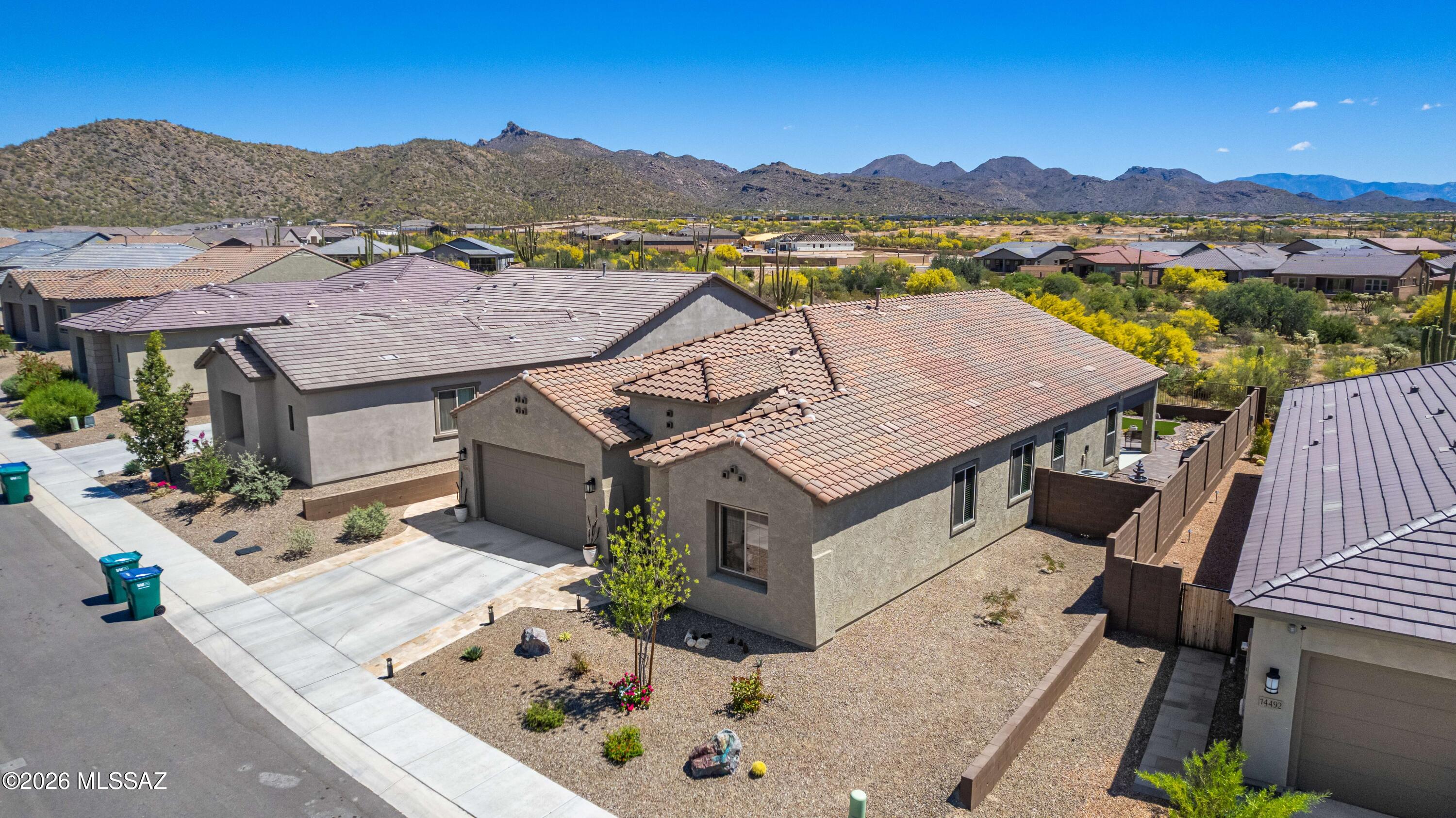 VIEWS, VIEWS, VIEWS! Experience elevated desert living in this beautifully appointed home, ideally situated on a desirable lot within the exclusive gated of Saguaro Reserve Community in Dove Mountain. 

Surrounded by breathtaking mountain vistas and dramatic desert landscapes, this home offers a rare blend of privacy, luxury, and natural beauty.  Great curb appeal welcomes you from the moment you arrive, featuring a concrete driveway with extended paver accents and a charming walkway that guides you to the inviting covered front porch.

Spanning 2,506 sq ft, this sophisticated home features a split floor plan, 3 bedrooms, 2 bathrooms, plus a den, and a spacious 2.5-car garage. Thoughtfully enhanced with modern upgrades, the interior includes a versatile den with elegant French doors fo an office or flex room, a custom wrought iron security gate, and a tailored patio shade for added outdoor comfort.

Designer touches abound, from the striking faux wood beam accents in the foyer to the gorgeous tile flooring that flows seamlessly throughout the main living areas, creating a refined yet welcoming atmosphere. Enjoy the formal dining area- perfect for entertaining friends or family. 

Inside, bright and open living spaces are enhanced by tile flooring that looks like real wood, abundant natural light, recessed lighting, and a refined neutral palette. The inviting living room showcases a built-in electric fireplace-perfect for relaxing evenings-along with picture-perfect windows that frame backyard views and sliding glass doors that seamlessly open to the patio, blending indoor and outdoor living. 

The well-designed chef's kitchen blends style and function with white shaker cabinetry with crown moulding, a designer backsplash, granite countertops, pendulum and recessed lighting, built-in appliances, and a large island with breakfast bar for casual dining. 

The private owner's suite offers a peaceful retreat with a walk-in closet, soft carpeting, its own ensuite bathroom with dual vanities and a large tile shower with a bench from floor to ceiling. Don't forget about the captivating views from this bedroom of the mountains and desert landscape. The remaining bedrooms also have soft carpeting and are ample size and share the hallway bathroom. 

The backyard is a true highlight--offering sweeping panoramic mountain views and stunning desert skies. Enjoy quiet mornings or sunset evenings under the covered patio, with plenty of space for recreation and outdoor gatherings.

A rare combination of comfort, style, and breathtaking views--this home is a must-see.
