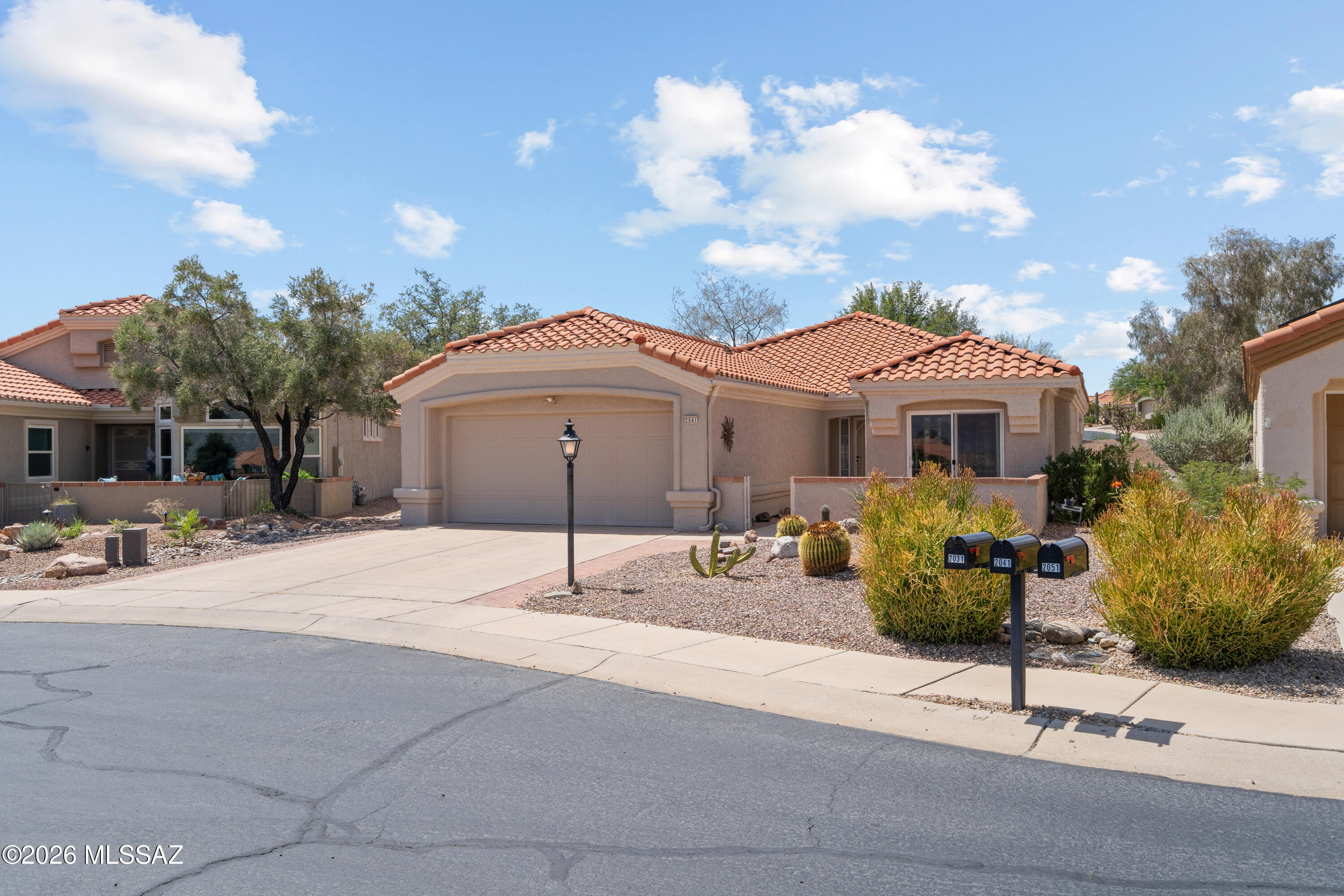 You'll love exploring this beautiful home in Sun City Oro Valley! Full of charm, this home offers uninterrupted view of the Santa Catalina Mountains from the inviting front patio. Situated at the end of a quiet street, this popular Mariposa model features an expanded bedroom with stunning views. The kitchen includes newer cabinetry, breakfast bar, and quartz & granite countertops. Improvements include a new tile roof (2025), fresh paint, and more. Spacious primary suite features built-ins, open airy bath and customized walk-in closet. Relax year-round on rear patio with its convenient rolling shade and enjoy the desirable north/south exposure. Experience active lifestyle that makes Sun City so popular with golf, fully equip gym, pickle ball, tennis, bocce & 170 plus clubs, and live music.