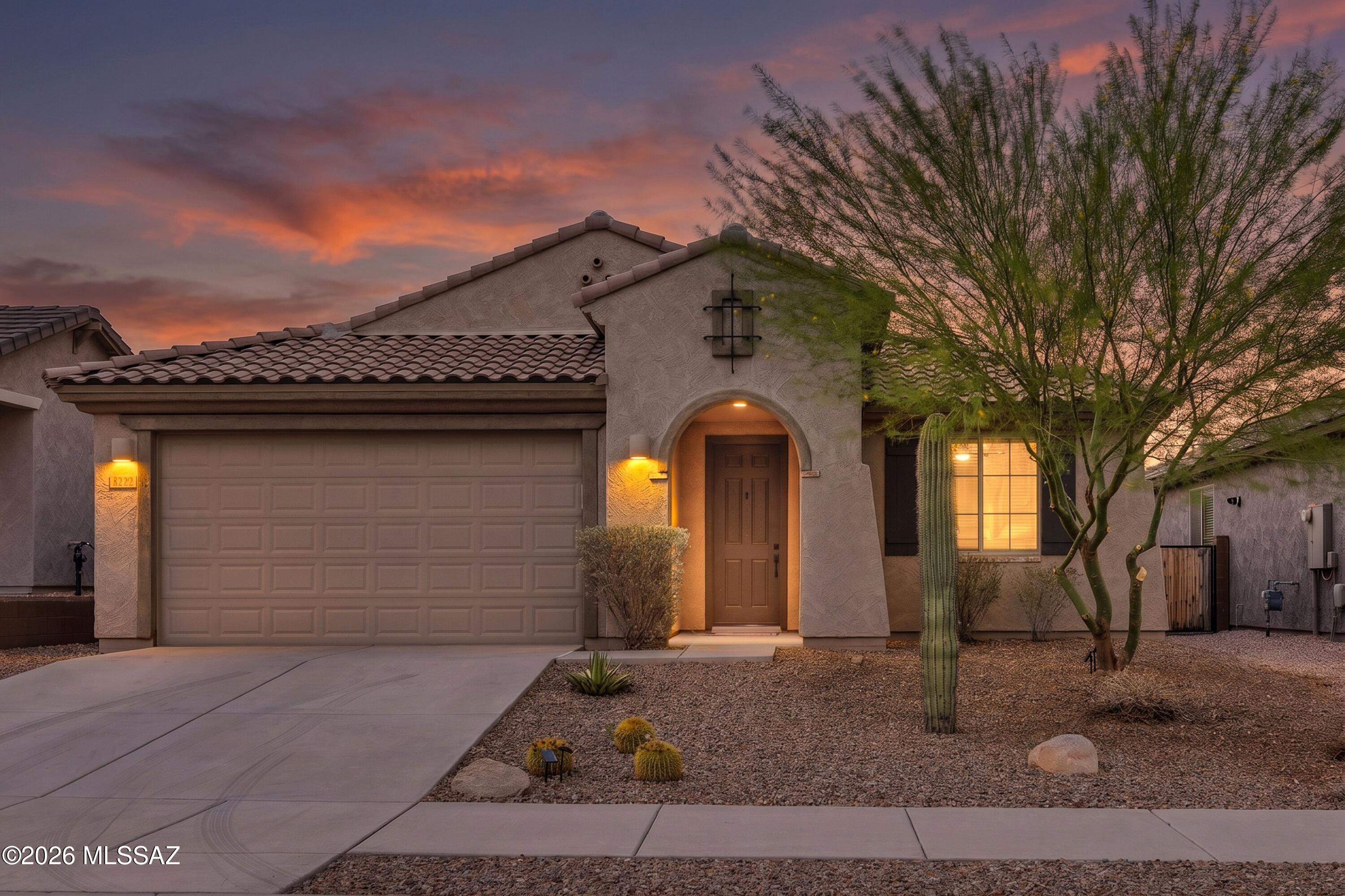 Welcome to this beautifully appointed 3-bedroom, 2-bathroom home located in the exclusive gated community of Lazy K Bar Ranch, surrounded by the breathtaking Tucson Mountains and adjacent to Saguaro National Park West. Built in 2020, this thoughtfully designed residence offers a desirable split-bedroom floor plan with a spacious primary suite, a versatile den, and an open concept living area highlighted by a striking brick accent wall. The expansive kitchen is ideal for both everyday living and entertaining, featuring generous counter space and seamless flow into the main living areas. Step outside to enjoy the covered travertine patio overlooking your private PebbleTec pool and spa, creating the perfect setting for relaxing or hosting. Completing the home is a spacious 2.5 car garage providing ample room for vehicles, storage, or a workshop also equipped with a Tesla charging station. Experience modern comfort and exceptional desert living in one of Tucson's most sought after gated communities.