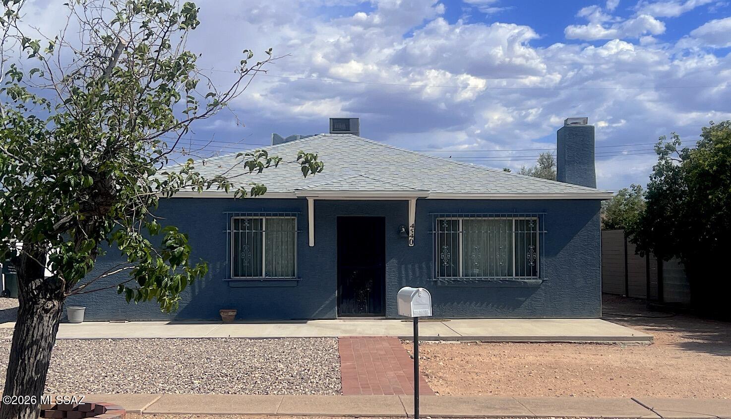 LOCATION - Poets Square. Classic, beautifully designed and remodeled home. First-time ever on market! Original mid-century modern with high-quality additions include: open, well-appointed granite-tile countertop kitchen; 2 baths one with clawfoot tub, the other with custom walk in shower; huge primary bedroom with flexible den/room floorplan. Move-in ready! Features:• 2BR+ Den, 2 Baths split floorplan • 
• Inviting dining-living with fireplace
and architectural features
• Full-size laundry/utility room • All appliances as shown stay • Ceramic tile, quality materials • 1-car Garage with remote PLUS Carport, Shop/Storage building & wrought-iron screened porch.