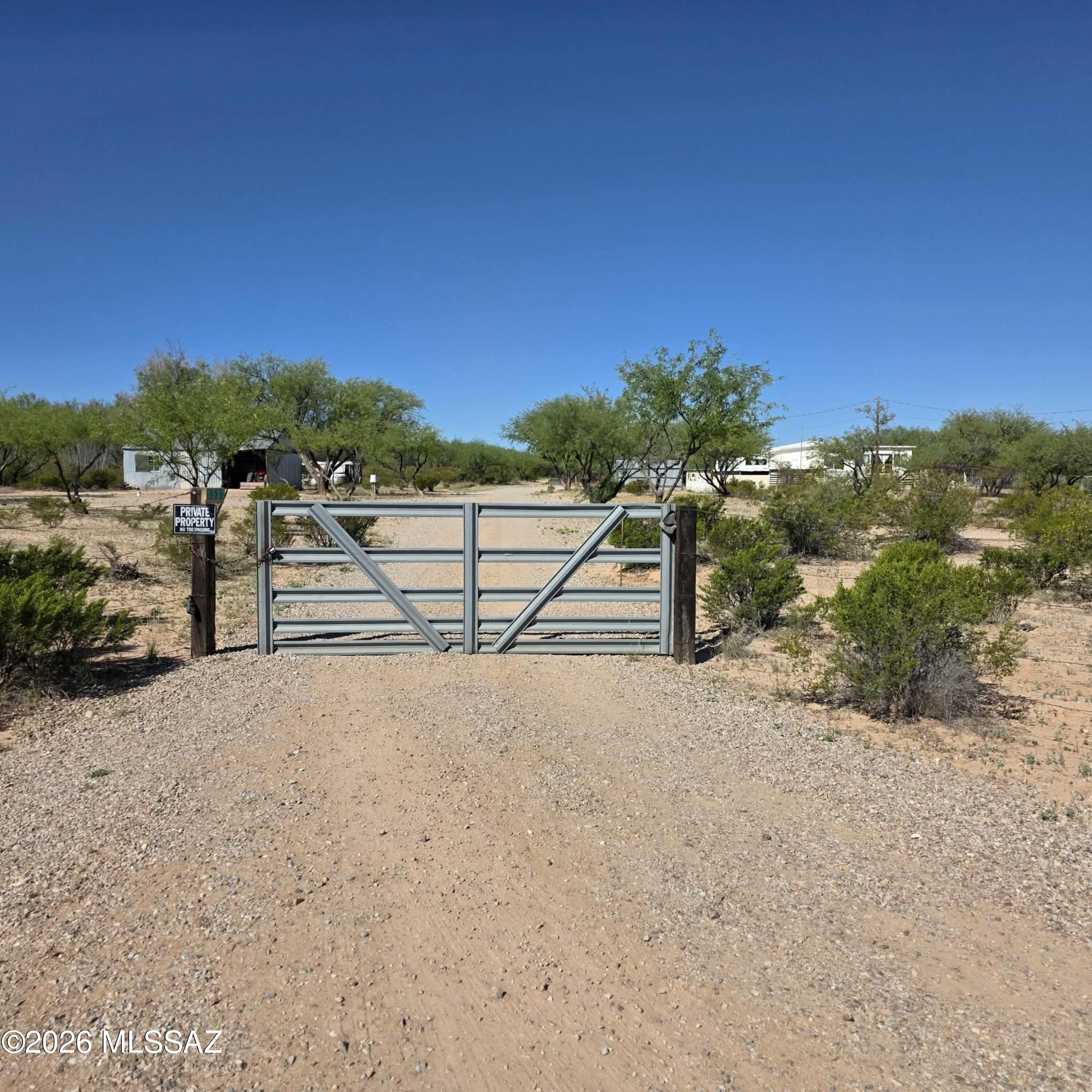 Welcome to your private desert oasis on 5 scenic acres in Benson! This versatile property offers the perfect blend of rural tranquility and functional living. The estate is fully equipped with a private well ensuring independence and efficiency.
The main home and spacious additions feature multiple living areas, a formal dining room, and an office. Outside, you'll find unparalleled space for animals and hobbies, including a shed with a tractor, a building with power, and multiple carports. Relax on the deck to take in the stunning views, or explore the garden area and expansive west-facing yard. With a gated driveway and plenty of room to roam, this property is a rare find for those seeking a self-sustained lifestyle.