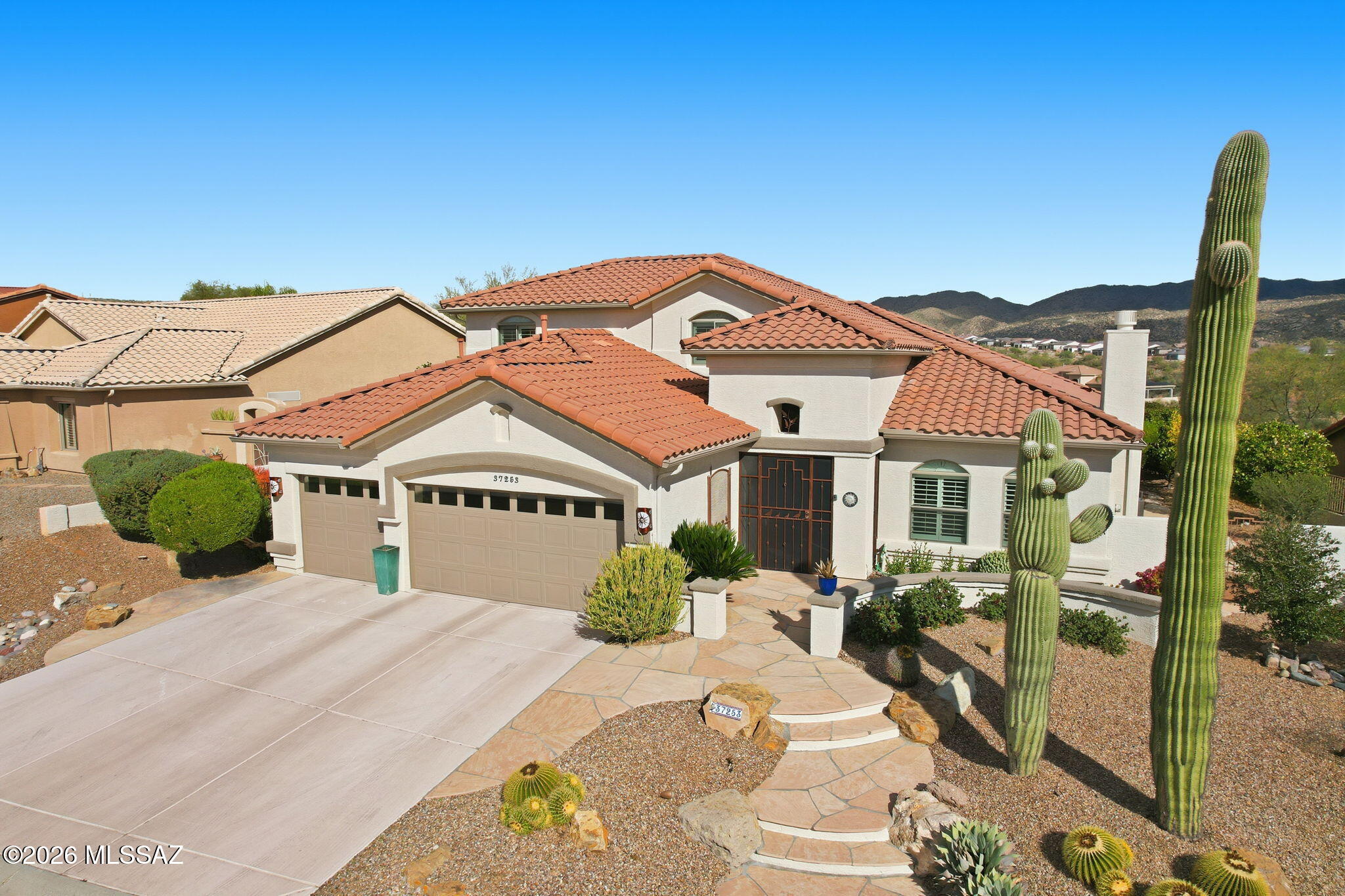 Spectacular mountain views from inside and back patio of this Durango home. Living room features a cozy gas fireplace while the family room and kitchen capture mountain views. Primary suite offers a sitting area, walk-in closet, soaking tub and shower. Upstairs casita w/two bedrooms and updated bath, perfect for guests. No carpet - tile and luxury vinyl flooring plus shutters throughout. Enjoy outdoor living with expansive flagstone patio, wrought iron and snake fencing, a kiva fireplace, and a gas line for grilling. Charming side patio boasts southern sun and citrus trees - tangelo and Meyer lemon. Additional features: updated irrigation, security door, alarm system w/owned hardware, and 3-car garage w/updated water heater, recirculation pump, and loop for a water softener.