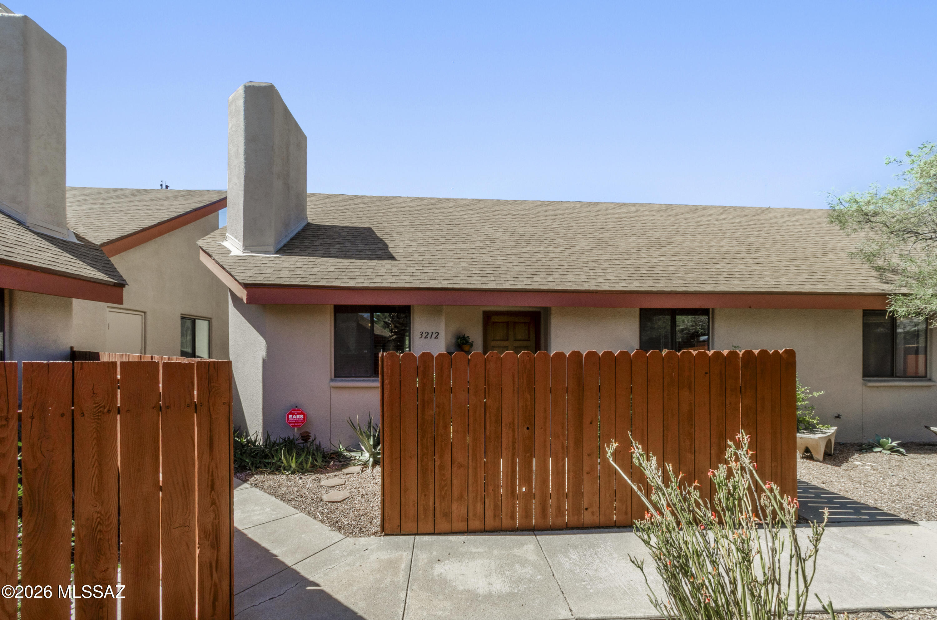 Freshly painted and filled with natural light, this inviting home features vaulted ceilings, bathroom skylights, and a cozy fireplace that creates a warm and welcoming atmosphere. The thoughtful layout offers bright, open living spaces and a private patio just off the primary suite, providing the perfect place to relax and enjoy Tucson's beautiful weather.

Located in a quiet community of only seven units, this home offers a rare combination of privacy and convenience. Just one mile from the University of Arizona campus, you'll enjoy easy access to downtown Tucson, shopping, dining, entertainment, and all the amenities the area has to offer. A wonderful opportunity to own a bright, low-maintenance home in an ideal central location.