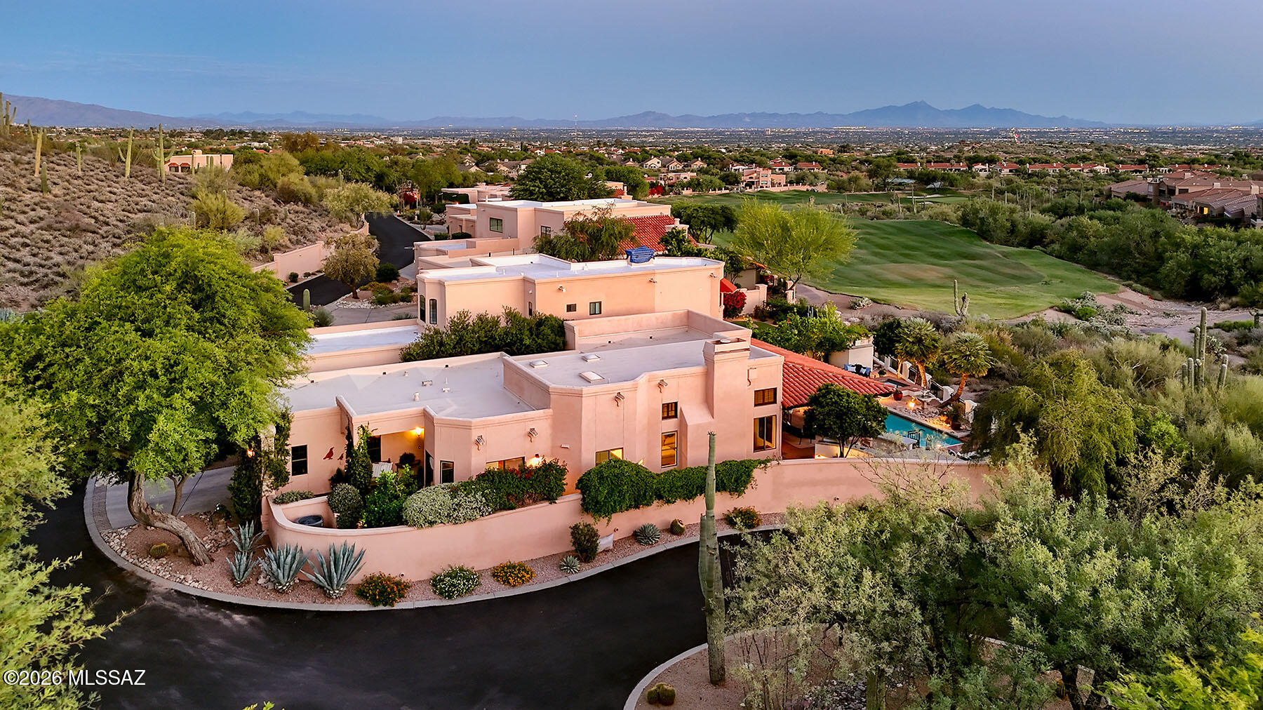 Experience timeless Southwestern elegance in this stunning Hacienda-style home nestled within the prestigious gated La Paloma community. Perfectly positioned on a premier golf course lot at the end of a quiet cul-de-sac, this exceptional residence captures breathtaking city lights and Catalina Mountain views. A private gated courtyard with a tranquil fountain and professionally landscaped grounds welcomes you inside, where soaring beamed ceilings, authentic Saltillo tile flooring, and a striking Spanish-inspired fireplace create an atmosphere of warmth and character. The spacious chef's kitchen features beautiful Talavera tile countertops, upgraded cabinetry with pull-outs and soft-close drawers, high-end appliances, and a casual dining area overlooking the picturesque courtyard. The luxurious primary suite offers a glass-enclosed sitting room and a beautifully remodeled spa-like bath. Step outside to an entertainer's dream backyard showcasing spectacular views, an expansive covered patio with automatic sunshades, outdoor fireplace, built-in BBQ area, refreshing lap pool, and relaxing spa--creating the perfect setting for year-round Arizona living.