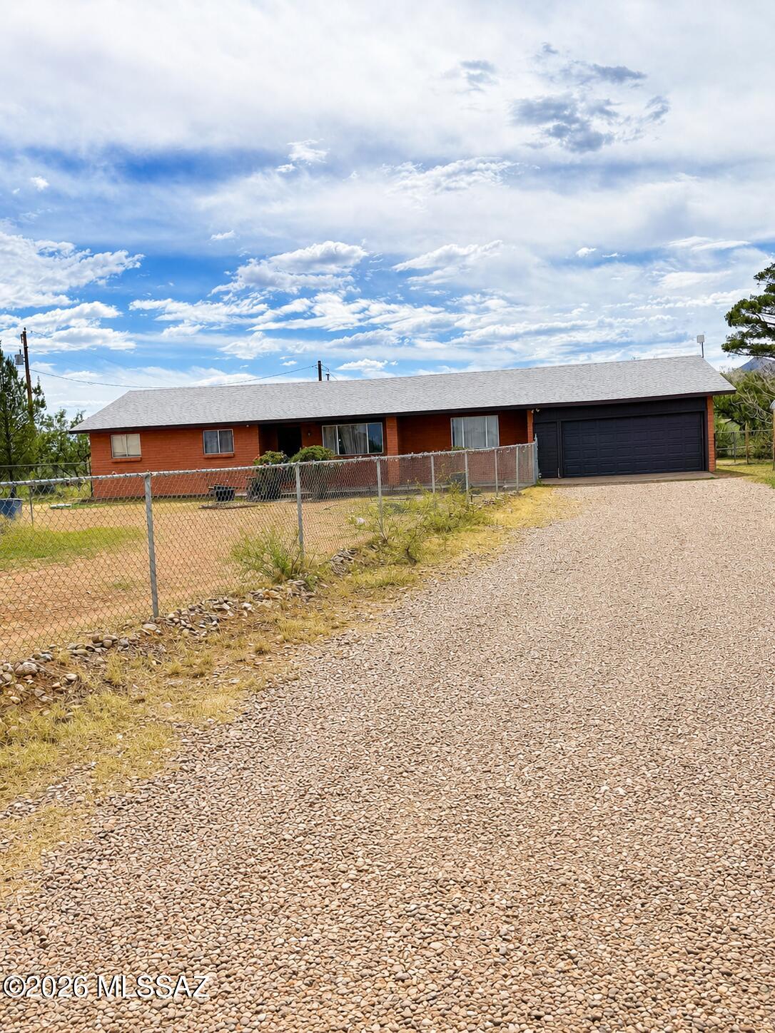 Discover the perfect blend of comfort and country living with this inviting 4-bedroom, 2-bath home situated on just over 2.4 fully fenced acres. The property features a private well, offering added independence and convenience. Inside, the spacious kitchen provides ample cabinet and counter space, making meal preparation and storage a breeze. The adjoining dining area creates the ideal space for gatherings and entertaining. A 2-car garage offers plenty of room for vehicles, tools, and extra storage. Enjoy the privacy and open space this property provides while still having all the comforts of home. Outdoor shed does not convey.