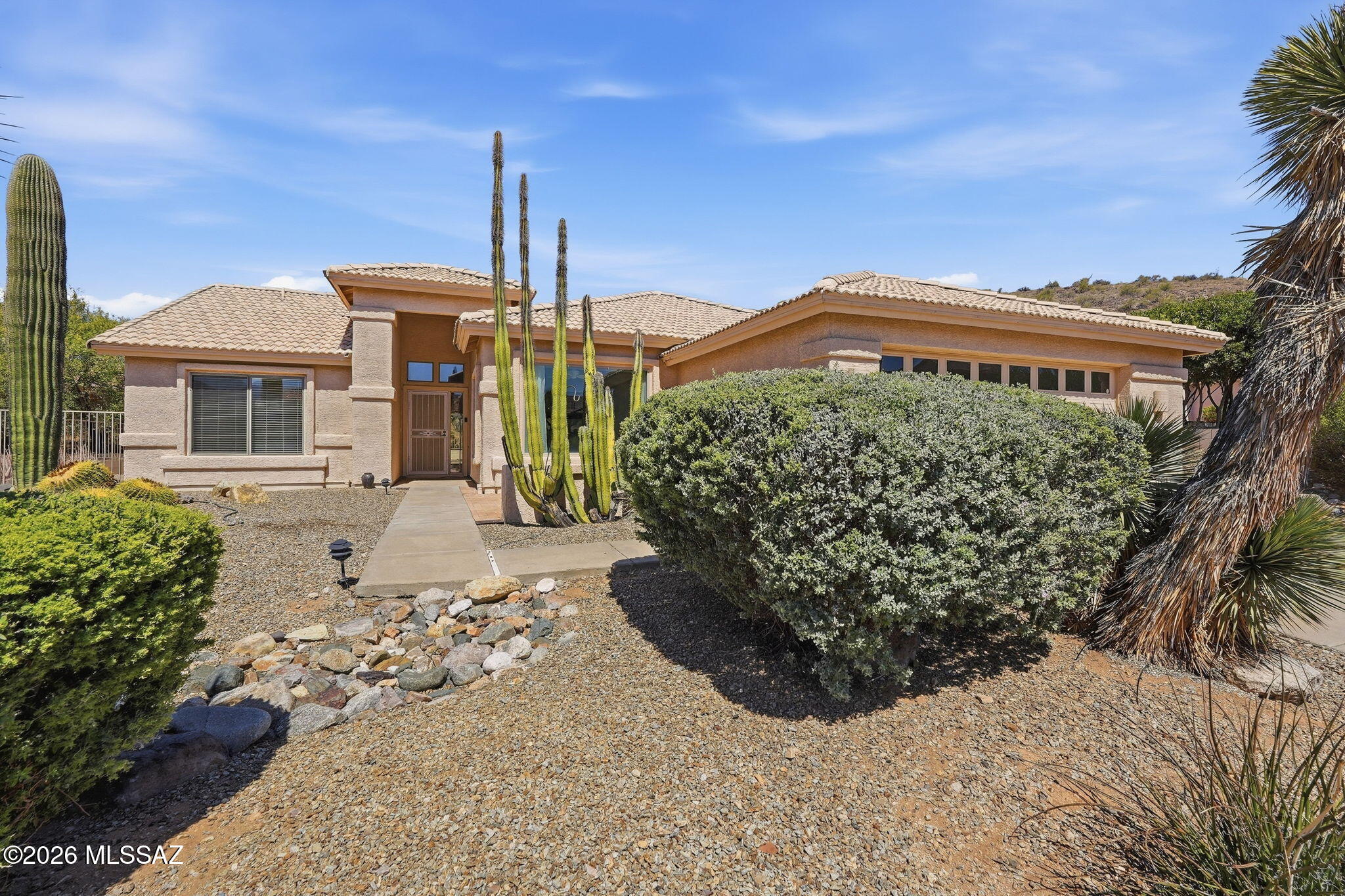 Welcome to your serene SaddleBrooke retreat! This inviting 2-bed + den, 2-bath home blends comfort and functionality with a backdrop of stunning mountain views. The spacious primary suite features a unique floorplan expansion, double-vanity bath, walk-in shower, and walk-in closet. The functional kitchen opens to a dining area perfectly positioned to enjoy the views. Relax on the covered patio overlooking a peaceful wash, surrounded by mature desert landscaping and majestic saguaros. Inside, enjoy new carpeting, tile flooring, abundant natural light, and a 2019 HVAC system. The garage offers extra storage and even a sauna! Move-in ready and ready to enjoy all the amenities, activities, golf, dining, and lifestyle that SaddleBrooke is known for.