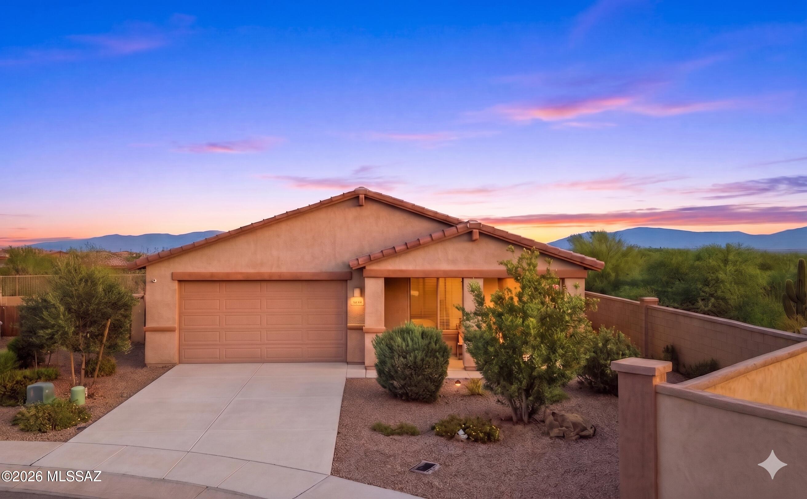 Location beckons with your private cul-de-sac home with 3-car garage and a north facing backyard - with no rear or east side neighbors, all in Rancho Sahuarita. Enjoy your extended front porch in the morning, and large backyard in the evening. Inside delight in upgraded elegance with new two-tone paint, new carpet, whole house water system, granite countertops, extended tile, and alarm system with cameras. A large primary suite faces north while the kitchen and living area are on the east, with an east facing stove. The view fencing allows views of Saguaro cactus and mountains in the distance, with an oversized backyard for enjoyment. An abundance of community amenities including a lake and parks, clubhouse, pools, walking paths / trails, and the top-rated schools - all in your backyard!