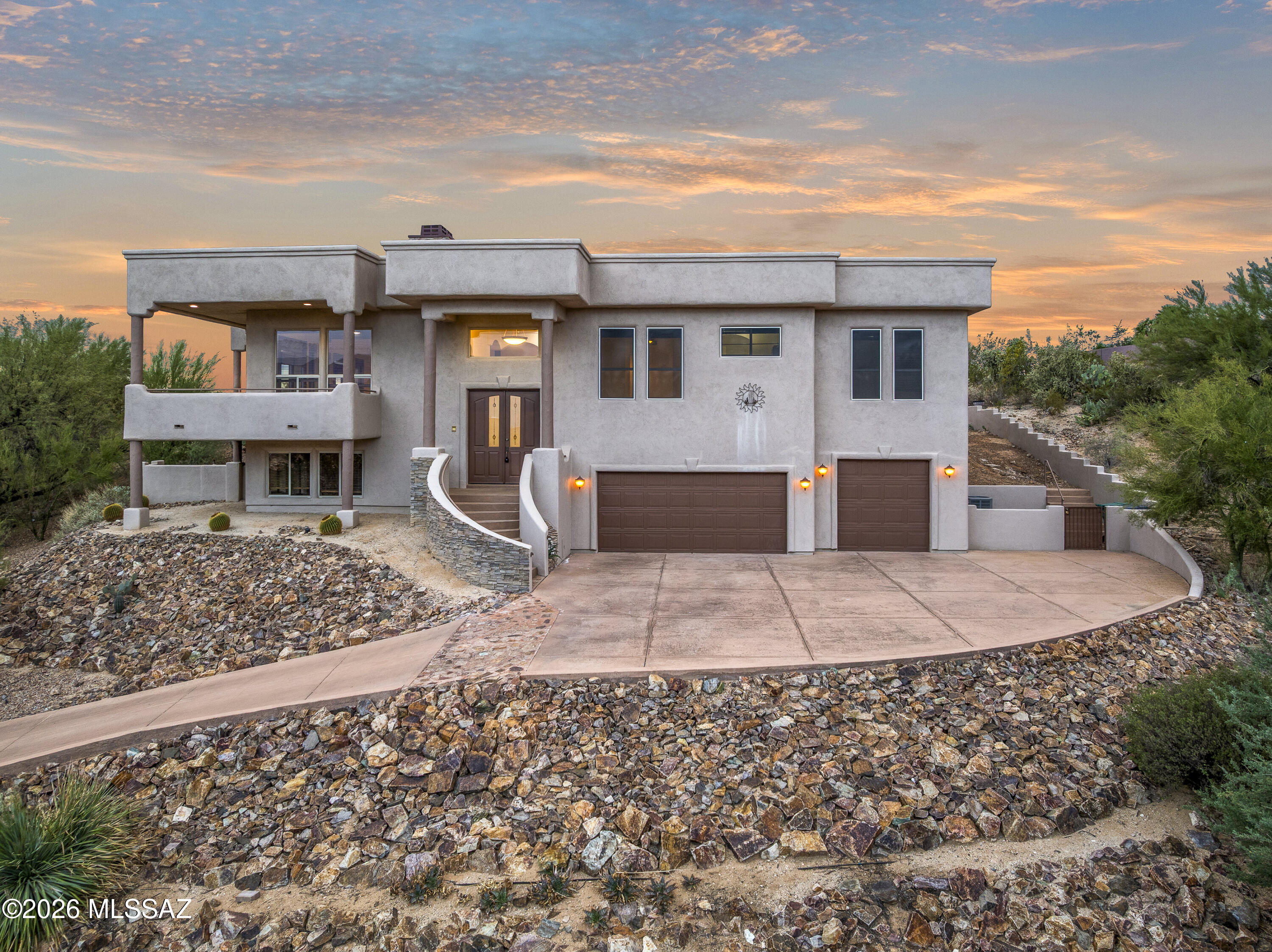 Experience the height of Oro Valley luxury in this magnificent contemporary estate (4BD/3BA/4,405sqft), perfectly situated on an oversized, private lot in Canada Hills! This ''better-than-new'' residence offers a sophisticated blend of modern design and the raw beauty of the Sonoran Desert, featuring sweeping views of the Pusch Ridge and Tortolita Mountains. The moment you enter through the grand foyer, you're greeted by an open-concept Great Room with soaring 12-foot ceilings and a massive wall of glass that perfectly frames the desert landscape. The chef's dream kitchen is the centerpiece of the home, featuring a sprawling granite island, professional-grade stainless appliances --perfect for the home gourmet and holiday gatherings alike. Retreat to the luxurious primary wing, a true sanctuary featuring a spa-inspired bath with a free-standing soaking tub, an enormous walk-in rain shower, and dual vanities. The split-bedroom floor plan ensures privacy for guests, while the primary suite office offers a quiet relaxation place with front-row mountain views. Step outside to your own private resort! The backyard is an entertainer's paradise, featuring an extended covered patio, a sparkling heated pool and spa, and a custom fire pit area for evening stargazing. With no neighbors behind you, the yard borders a lush natural wash, providing a serene backdrop of native saguaros and visiting wildlife. Complete with a 3-car tandem garage and minutes from the shops at Oro Valley Marketplace, this home offers the ultimate Arizona lifestyle!