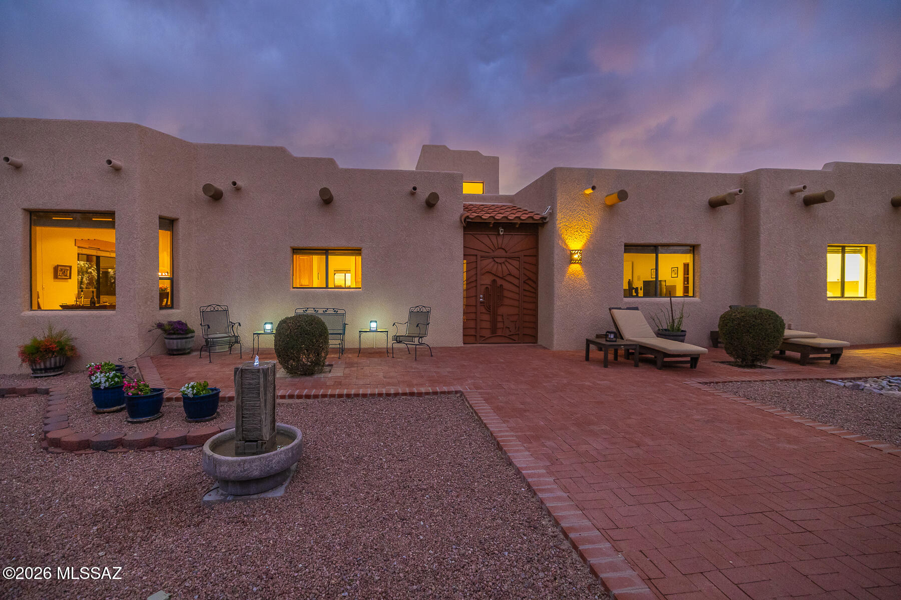 Set on nearly 4 acres in La Cebadilla, this custom masonry home offers a rare combination of privacy, mountain views, equestrian amenities, and authentic desert living. Expansive views of the Catalina and Rincon Mountains create a beautiful backdrop, while the inviting courtyard entry leads into a warm and character-filled interior with wood-beamed ceilings, viga details, and large windows that capture the surrounding desert landscape. The 3,126 sq. ft. floor plan features a spacious family room, formal dining room, casual dining area, and an open kitchen designed for comfortable everyday living and entertaining. Outdoor living is a highlight, with a generous covered patio that wraps around the home and offers multiple places to relax, dine, and enjoy the peaceful setting. The home includes 3 bedrooms and 2 full baths, along with an oversized laundry/craft room that provides excellent flexibility for hobbies, storage, or workspace. Equestrian improvements added in 2023 include 3 stalls, turnouts, wash rack, hay storage, and trailer access. Additional features include a 3-car garage (including an RV garage) and abundant storage. La Cebadilla is known for its spacious homesites, equestrian lifestyle, neighborhood lake, and access to riding and hiking trails. A special opportunity to enjoy space, views, function, and the relaxed desert lifestyle in one of Tucson's most distinctive communities.