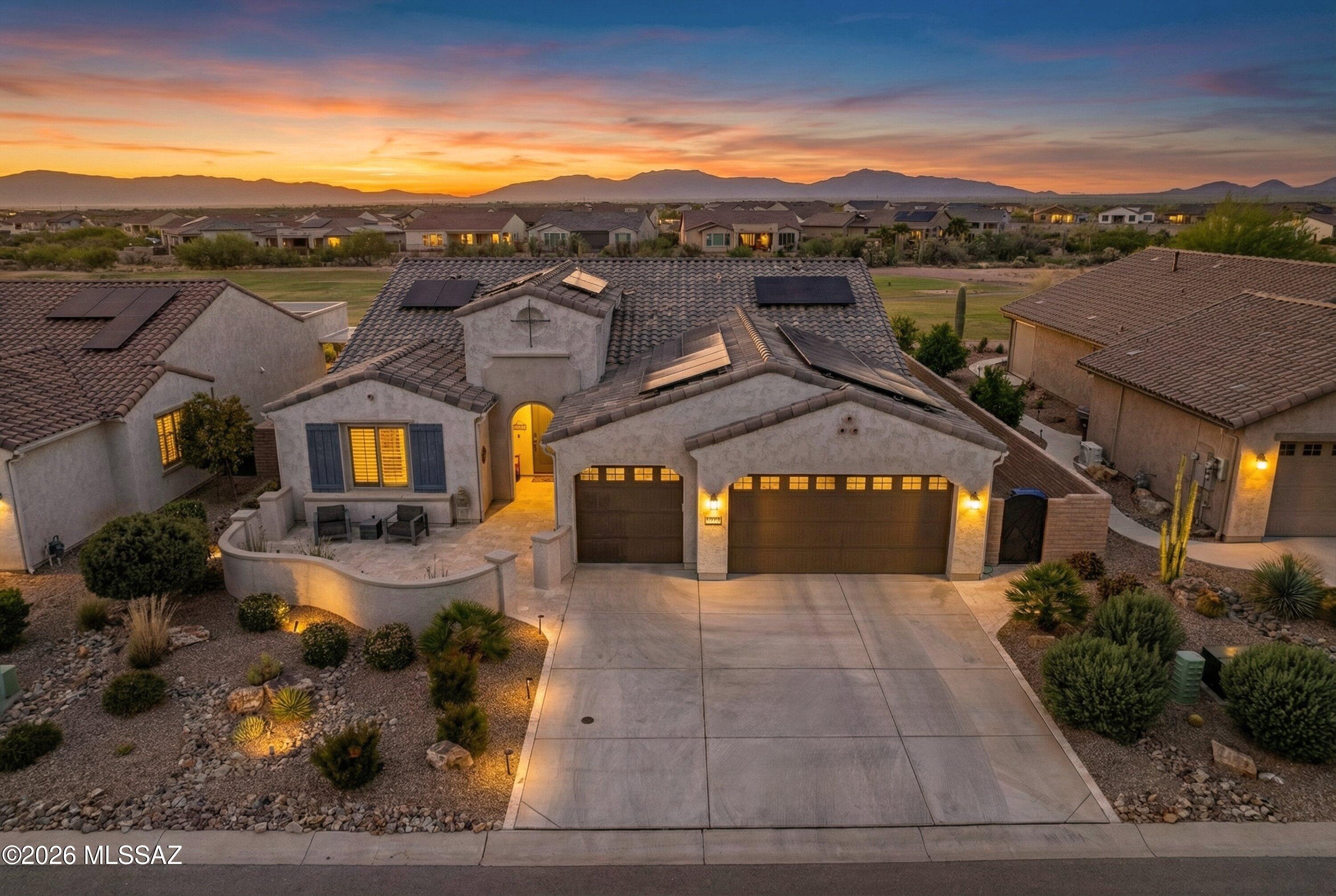 Built in 2021 and set on a premier golf course lot, this VIENTA 2,308 sq ft highly upgraded residence delivers the ultimate blend of luxury living and sports-focused lifestyle. Designed for those who love to play, watch, and entertain, this home offers a move-in ready alternative to new construction--without compromise. WHY BUILD NEW?  The open-concept layout is both refined and functional, ideal for hosting game-day gatherings or relaxed everyday living. The chef's kitchen anchors the home with an oversized quartz island, premium cabinetry, walk-in pantry, wet bar & wine cooler, and a solar tube that fills the space with natural light--perfect for prepping, serving, and socializing. Energy-efficient upgrades, including a hot water recirculation system and whole-house water softener, ensure comfort and efficiency. Plantation shutters, upgraded lighting, ceiling fans, and luxury flooring throughout elevate the experience.  The primary suite is designed as a private post-round retreat, featuring direct access to the backyard through a 10'x8' large sliding glass door, a spacious walk-in custom closet, and a spa-style bathroom with an oversized walk-in shower-ideal for unwinding after a day on the course. A standout feature for sports enthusiasts, the versatile den includes built-in Murphy twin beds and custom cabinetry, easily transforming into a guest space, media room, or game-day lounge. The extended 3-car garage--with a 4-foot extension, built-in cabinetry, and epoxy flooring--offers ample space for vehicles, golf carts, gear, and storage.  Step outside to your personal sports and entertainment hub. The custom-designed sport pool and spa invite both recreation and relaxation, all set against sweeping golf course and mountain views. The covered patio, outfitted with built-in TVs, creates the ultimate outdoor viewing experience--perfect for hosting unforgettable game days or enjoying a quiet evening under the Arizona sky.