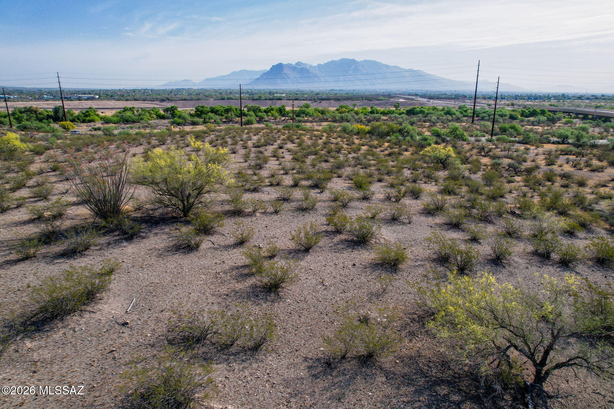 Discover the perfect blend of space, serenity, and convenience with this approximately 4-acre vacant parcel nestled in the scenic Tucson Mountain foothills. Lightly dotted with native vegetation and minimal cacti, the property offers an ideal canvas for  your custom home, or investment opportunity. Zoned **Suburban Ranch**, the land provides flexibility and room to spread out while still maintaining a peaceful, rural feel.  The front of the property enjoys **direct frontage along paved Silverbell Rd**, ensuring easy access. **Electric available at the lot line**, & **city water may be available for tie-in**; if not, a private well & septic will be required. With desert views, dramatic sunsets, & natural beauty of the surrounding mountains. This property provides a perfect setting!