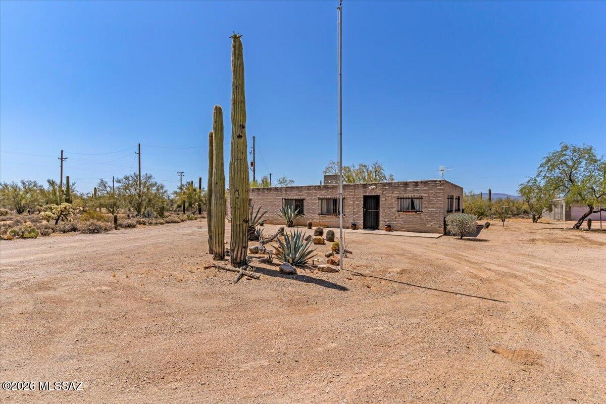 Perfect blend of privacy and potential on this expansive property spanning over 4 acres, where you are treated to breathtaking 360-degree mountain views from every angle. This estate is a dream for hobbyists and collectors alike, featuring a massive detached garage and workshop with ample space to house more than three vehicles alongside your tools and gear. Inside, the home boasts generously sized rooms that provide a sense of scale and comfort, including a kitchen updated with newer appliances. While the bones are solid and the setting is serene, this residence is truly a blank canvas ready for your new ideas and personal touch. Are you looking to create a modern equestrian retreat or a quiet desert sanctuary, this unique acreage offers the space and scenery.