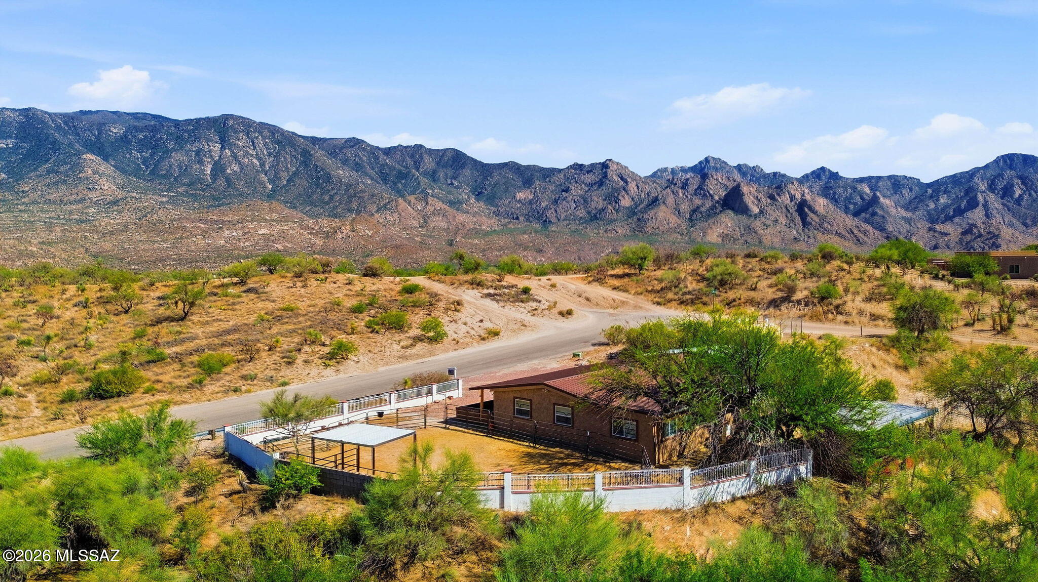 Range-Priced from $299,000 to $310,000.Updated 3-bedroom/2bth +Bonus Room with stunning mountain views, on over an acre of land! Porch faces the Santa Catalina Mountains & a detached garage inc cooling. Metal roofs & new windows. Inside, a semi-open layout connects the living & dining areas, with warm neutral tones, wood-look floors, & plenty of natural light throughout. The newer kitchen features stainless steel appliances and generous counter space.A versatile AZ room is perfect for year-round entertaining. Main bedroom includes a private bath and walk-in closet, while an indoor laundry room and pantry keep things practical. Backyard features a covered patio, a ramada, & horse corral. Side yard inc 2nd horse corral. Paved road up to the home which sits up high