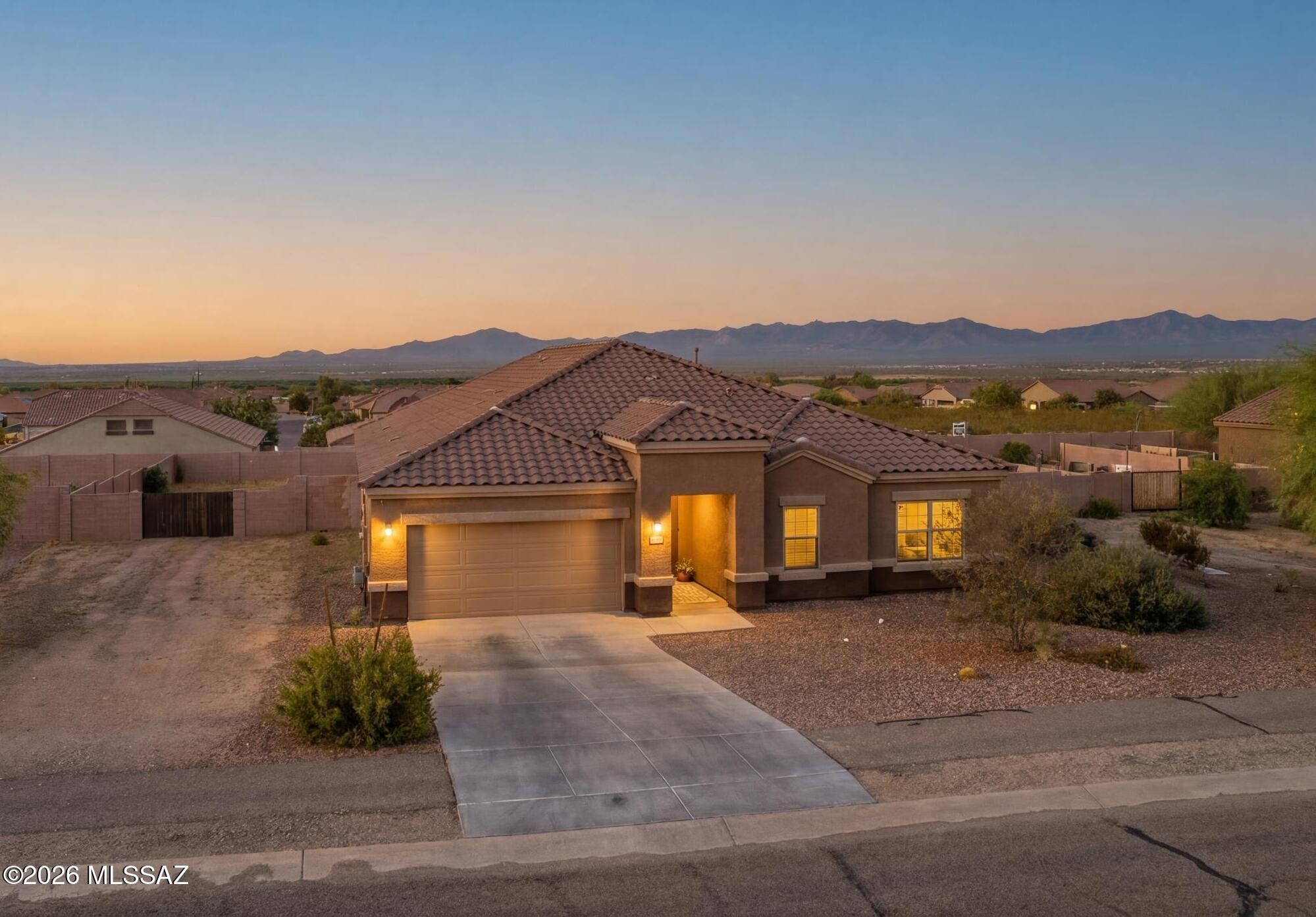This beautiful single-story home is situated on one of the largest lots in the community. Featuring four generously sized bedrooms plus a versatile den, this exceptional property offers nearly half an acre with endless possibilities. The flexible den is perfect for a home office, playroom, fitness room, or guest space, while the thoughtfully designed floor plan provides comfortable everyday living and effortless entertaining. Enjoy the benefits of newer construction with modern finishes, energy-efficient features, and a layout designed for today's lifestyle.

The expansive homesite offers rare privacy and ample room for a pool, outdoor kitchen, workshop, or the backyard retreat you've always envisioned. Located in a desirable Sahuarita community, this property combines the convenience and space all within reach. Home has a grand and open living design with an expansive kitchen island, walk in pantry, stainless steel appliances, and tons of cabinetry.

Don't miss your chance to own this exceptional property that perfectly balances modern comfort, generous space, and the best of Arizona living with amazing mountain views.