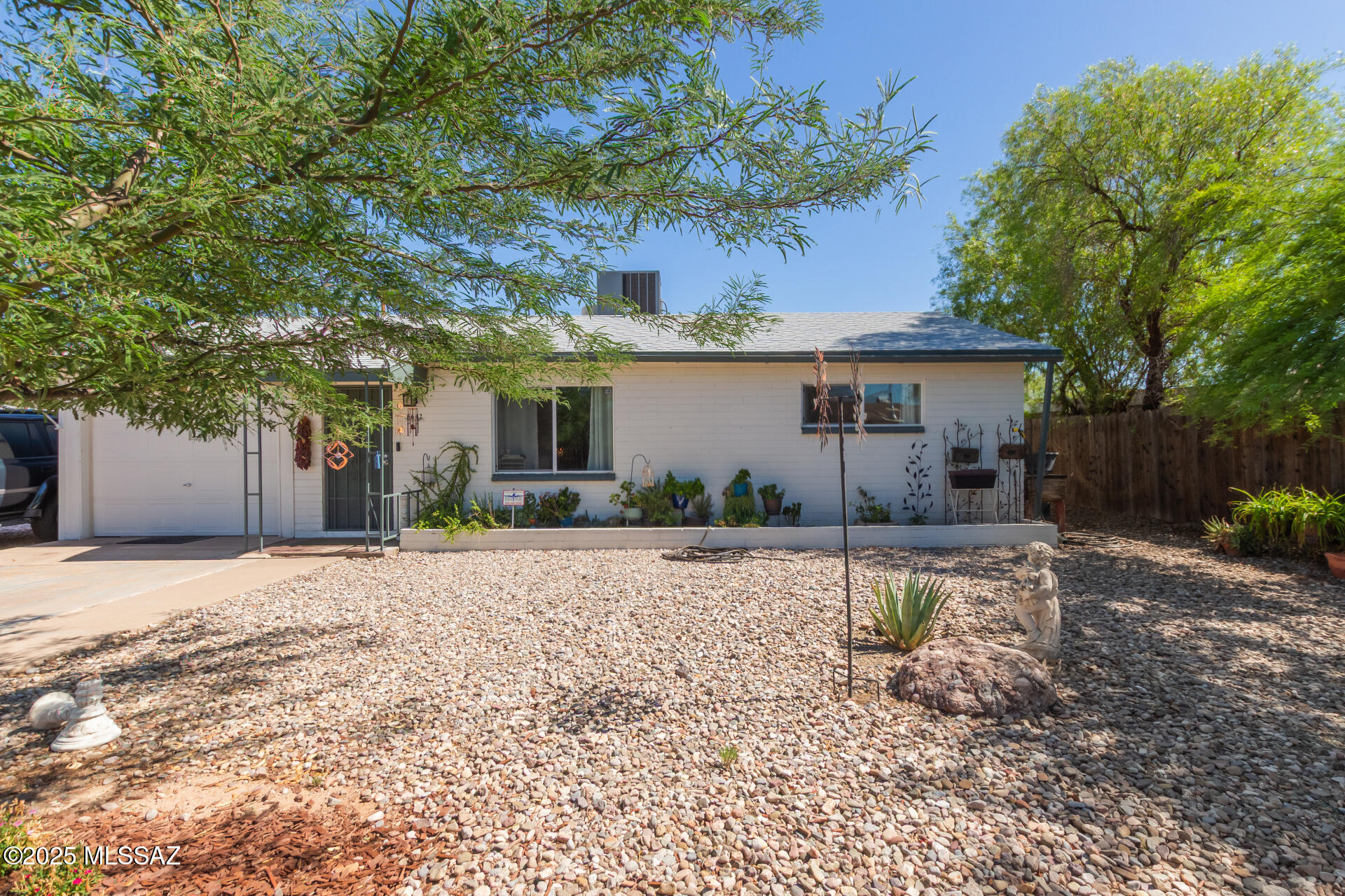 Charming Central-East Tucson Home! This cozy 4-bedroom, 2-bath home features a desirable split-bedroom floorplan and thoughtful updates throughout. A new roof was installed in 2023, and both the interior and exterior have been freshly painted. The kitchen offers updated paint and a newer gas stove, making meal prep a breeze. You'll love the dedicated laundry and pantry room with a convenient back door leading to the backyard. The outdoor space has been partially updated with brickwork and low-maintenance artificial turf, perfect for relaxing or entertaining. Out front, enjoy a colorful yard filled with flowers, a beautiful Chilean Mesquite tree, and a brand-new fence. Complete with a one-car garage, this home is Ready for it's new owner. Truly a must see!
