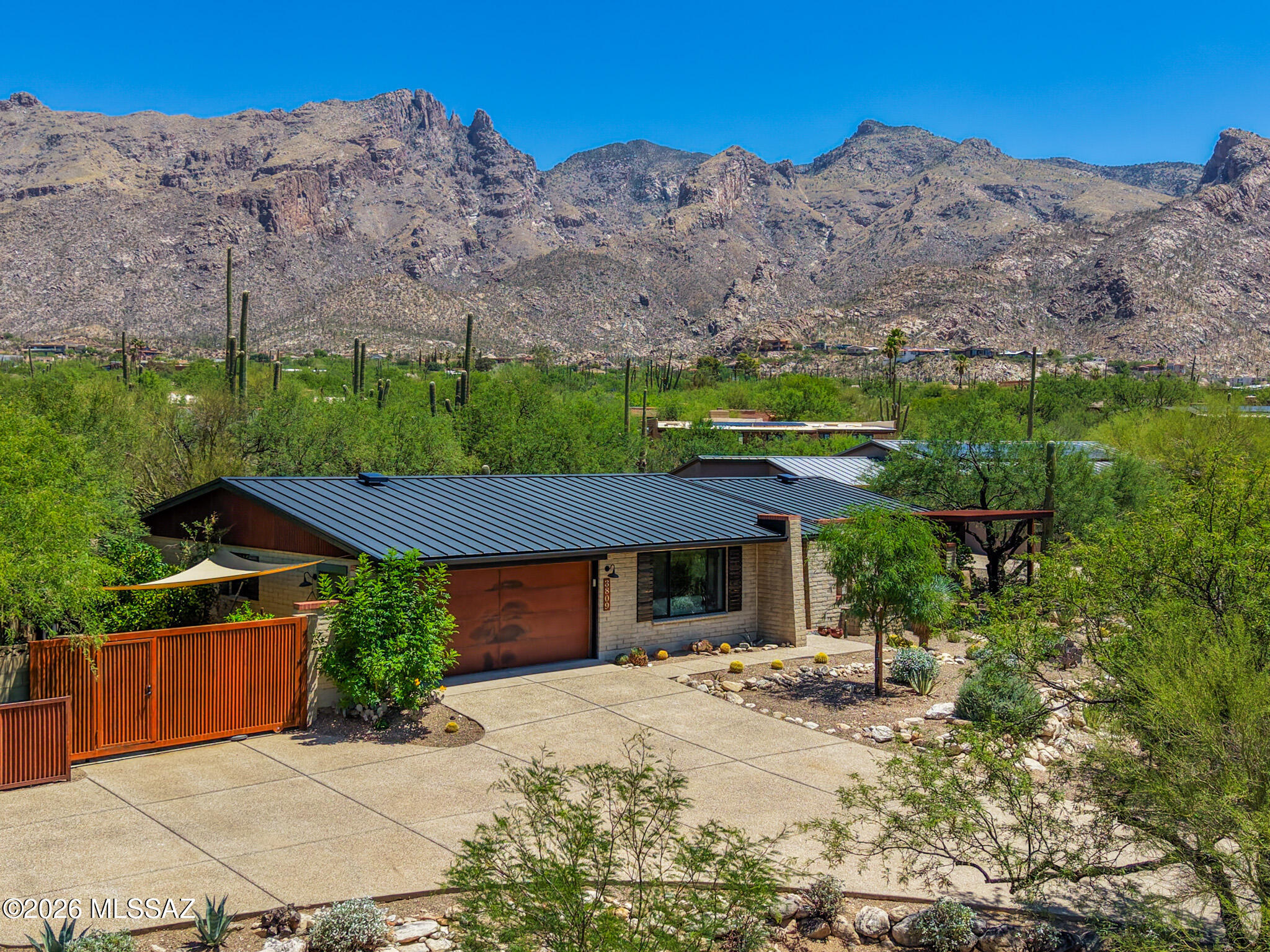 Wonderful Catalina Foothills home!  This modern classic home was completely remodeled by a local builder in 2020. On an elevated lot, situated for maximum privacy, city views from front and mountains to rear. Landscaping is native and well-maintained. Rebuild took the house down to foundation, with emphasis on creating a sense of spaciousness and light. New plumbing, electric, HVAC, doors, windows and roof. Floor is concrete overlay throughout. Master suite is stunning. Separated guest room. Existing office could convert to a fourth bedroom w/addition of a closet. All energy-efficient appliances and excellent insulation for low utility costs. Western side yard has mature citrus and gardening boxes with timer-irrigation installed.  Rare & amazing opportunity here in the Foothills! Truly one of a kind opportunity.  No details left undone.  Home was expanded with new foundation in the rear to allow for a large master suite looking up to the Catalina Mountains.  Huge windows allowing all the Arizona light in.  West side yard with mature citrus and gardening boxes.  Terraced backyard - a modern oasis in the desert.  All energy-efficient appliances and excellent insulation for low utils!