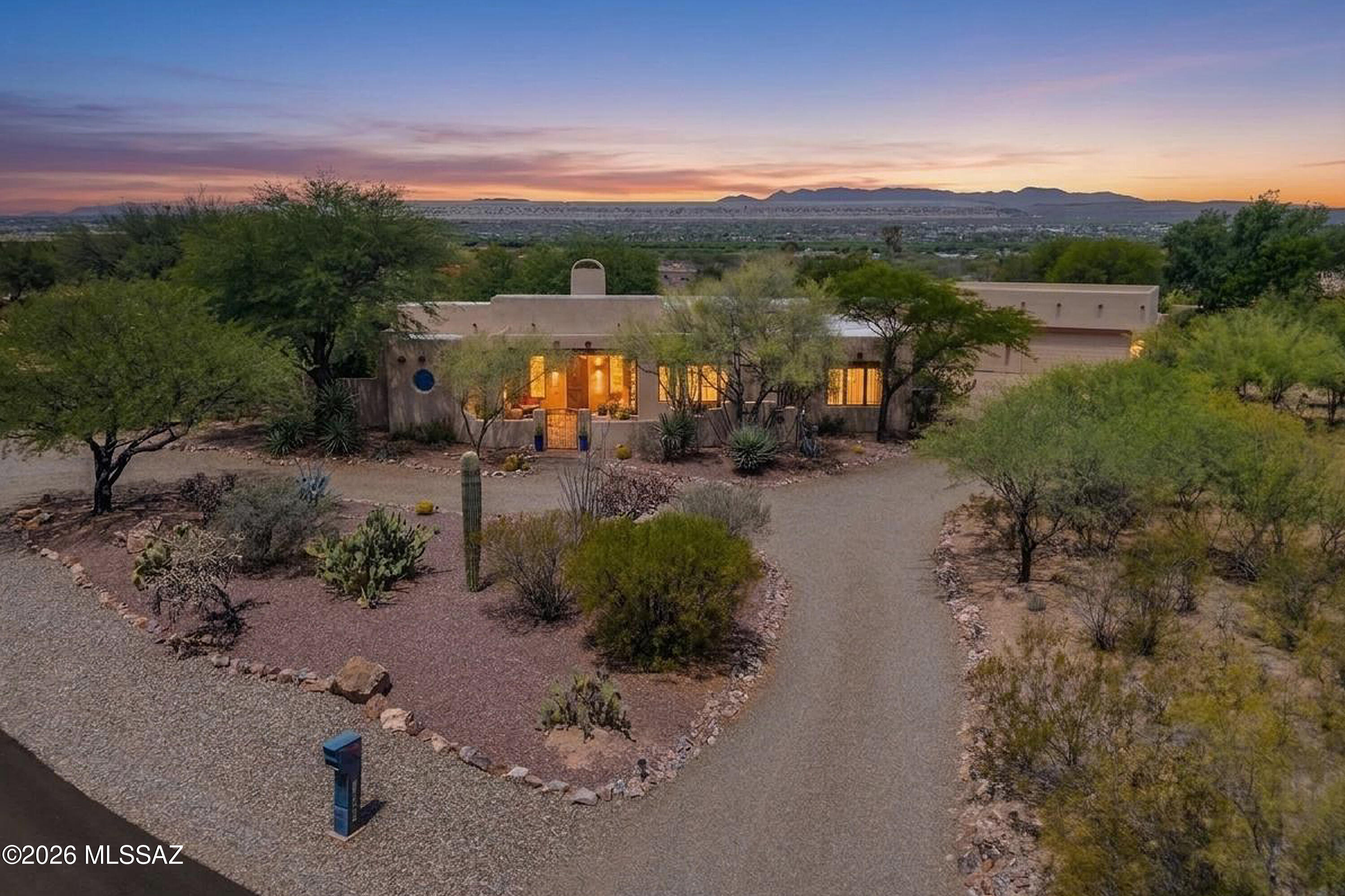 Nestled on a spectacular .55-acre desert homesite in Madera Reserve, this Spanish-inspired hacienda blends timeless Southwest architecture with exceptional indoor-outdoor living. The property features a 2,333 sq.ft. main residence, a 700 sq.ft. Casita, 4 BR, 3.5 BA, and an extraordinary garage complex offering more than 1,900 sq. ft. of garage and workshop space to accommodate up to 6 vehicles - an exceptional opportunity for collectors, hobbyists, and prized automobiles. A circular driveway and mature desert landscaping create impressive curb appeal, while the gated front courtyard welcomes you into a warm and inviting foyer. The spacious great room showcases authentic Southwestern character with peeled wood columns, exposed beam ceilings, dry bar, and a natural gas kiva-style fireplace. The chef's kitchen is designed for both everyday living and entertaining, featuring a gas range with griddle, convection wall oven, stainless appliances, granite tile counters, walk-in pantry, and breakfast bar accented with Spanish murals. Adjacent casual dining space offers seamless access to the expansive wrap-around rear patio, as does the great room, creating the perfect setting for Arizona's indoor-outdoor lifestyle.

A formal dining room overlooking the front courtyard provides an elegant space for intimate gatherings, while custom wood double doors in the hallway reveal a stunning display area for fine serving ware and collectibles. The owner's suite serves as a private retreat with direct patio access and a beautifully remodeled bath featuring dual vanities, a jetted soaking tub, separate shower, and walk-in closet. A desirable split-bedroom floorplan provides privacy for family and guests. Two guest bedrooms, a full guest bath, separate powder room, and spacious laundry room complete the main residence. Step outside to the wrap-around rear patio to access the Casita through impressive 8' wood double doors. This versatile space features a large common area ideal for hobbies, crafts, a home studio, or in-law suite, along with a spacious bedroom area and private bath showcasing an all-tile snail shower and custom Spanish tile vanity.

Relax and enjoy the extended outdoor living space from the expansive wrap-around covered patio overlooking a tranquil rear yard enhanced by mature desert landscaping, pet-friendly artificial turf, four mature citrus trees (grapefruit, orange, lemon, and lime), and a soothing water feature. The elevated homesite captures stunning city lights, mountain vistas, and the natural beauty that makes Southern Arizona so special.

Car enthusiasts and hobbyists will appreciate the exceptional garage accommodations with space for 6 vehicles. The attached 3-car garage includes a utility sink, ample storage, and access to the main house and rear patio. The separate, climate-controlled 2-car garage with AC is configured to accommodate up to 3 vehicles with the existing automotive lift and also features 268 sq.ft. of workshop space. Add a second lift to accommodate a 7th vehicle. This is a rare opportunity for storage, projects, overheight vehicles, or prized automobiles, making it an ideal setup for collectors, craftsmen, and automotive enthusiasts alike.

Surrounded by stunning natural desert beauty and showcasing authentic Southwestern design throughout, this exceptional Madera Reserve estate offers a truly unique Arizona lifestyle. Residents will also enjoy access to Green Valley Recreation's extensive amenities, including multiple recreation centers, swimming pools, fitness facilities, pickleball and tennis courts, clubs, and a wide variety of social activities that make Green Valley one of Southern Arizona's premier destinations.