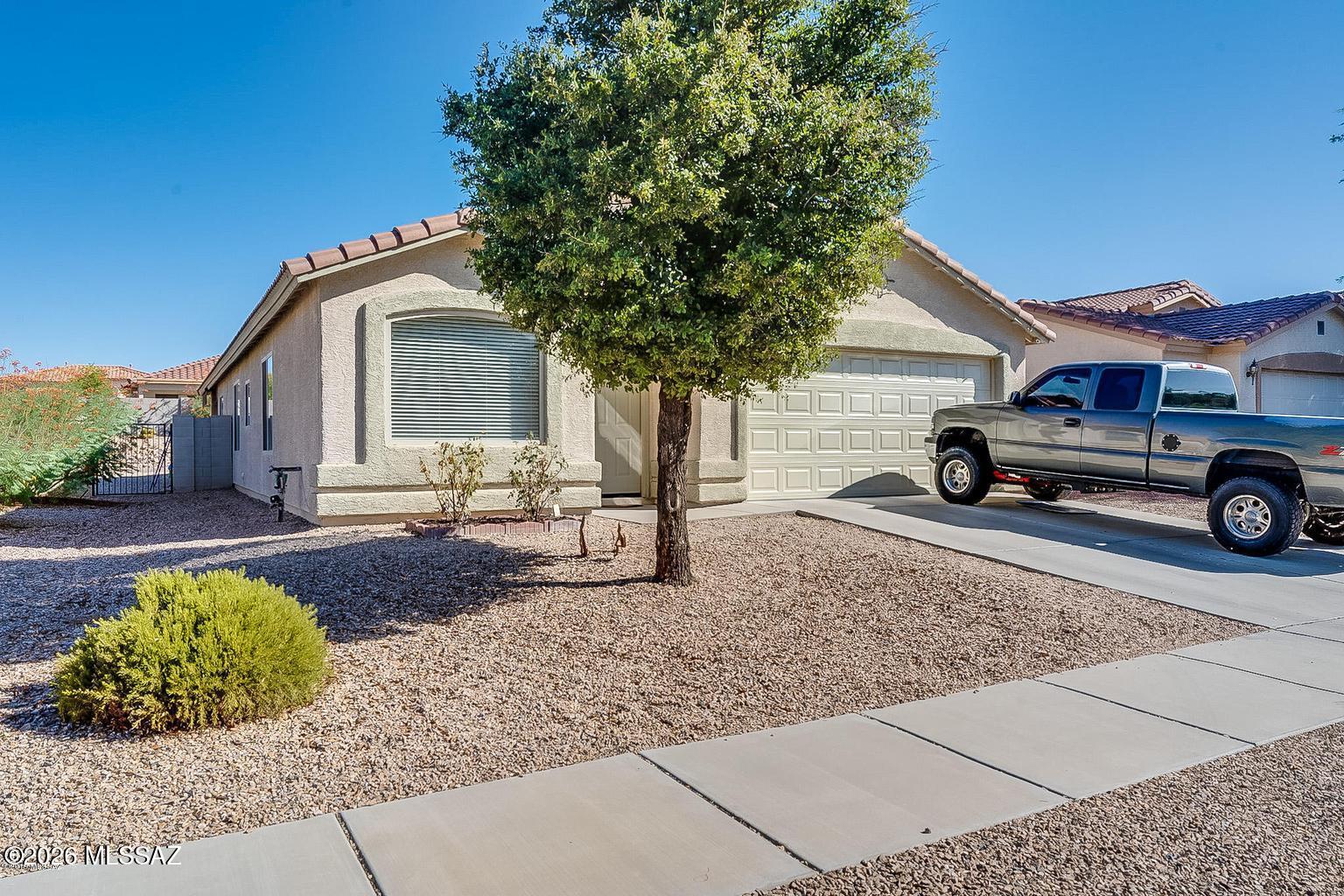 Welcome to this warm and inviting family home in the highly sought-after Cortaro Ranch community. Offering 4 bedrooms, a dedicated den, and 2 bathrooms, this spacious floor plan provides the flexibility and comfort today's families are looking for.

Step inside to discover vaulted ceilings, abundant natural light, and an open-concept living space designed for everyday living and entertaining. The well-appointed kitchen features a center island, gas range, pantry, and plenty of cabinet space, making it the perfect gathering place for family and friends. The thoughtfully designed split-bedroom floor plan offers privacy for the primary suite, while the secondary bedrooms share a convenient Jack-and-Jill bathroom. The additional den provides endless possibilities as a home office, playroom, media room, or workout space.

Outside, you'll find a spacious backyard with room for children, pets, gardening, or simply relaxing under Arizona's beautiful skies.

What truly sets this home apart is its amazing location. Conveniently situated just minutes from I-10, commuting anywhere in Tucson is quick and easy. You'll also enjoy being close to shopping, dining, schools, parks, and everyday amenities. Outdoor enthusiasts will love the nearby Tucson Loop bike path, offering miles of scenic biking, walking, and running trails right at your fingertips.

Priced at $359,000, this move-in-ready home combines space, functionality, and an unbeatable location, making it the perfect place to create lasting memories.