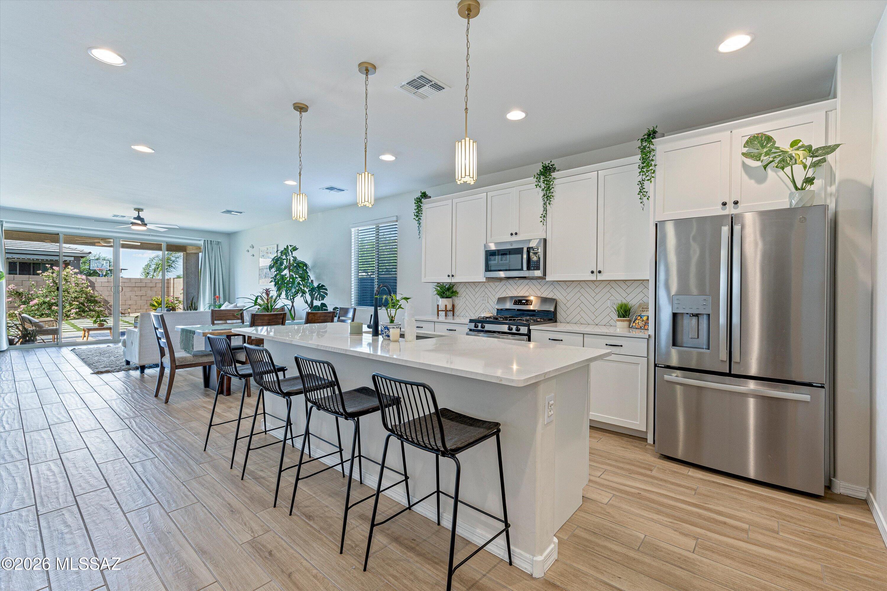 Premium 5-Bed Cul-De-Sac Retreat with Unmatched Storage in Gladden Farms
Welcome to your own private, energy-independent sanctuary! Nestled perfectly at the end of a quiet, premium cul-de-sac, this gorgeous 2,046 sq. ft. single-story home features the highly sought-after Richmond American ''Sapphire'' floorplan. Step through the custom stylized metal security front door into a light-filled interior tied together by premium, textured Saddle Brook Oak Trail wood-look porcelain tile flooring. This entire home functions as a clean, classic, timeless, and completely neutral move-in ready canvas, giving you the perfect backdrop to decorate and accent in any direction you choose.

The heart of the home features a chef-ready kitchen boasting premium quartz countertops, a stunning herringbone backsplash, and elegant, full-overlay shaker cabinetry. Best of all, all major appliances are included in the sale, including the refrigerator, washer, dryer, and a ready-to-use water softener system. Outside, your property blends seamlessly into a beautiful community park, offering sweeping green views, a playground, and a gazebo right outside your door, all with zero maintenance on your part!

Highlight Features:
-Fully Owned Solar (Zero Utility Shock): Say goodbye to Arizona summer utility bills with a fully paid off, 100% owned solar system that transfers completely to the buyer with no lease or loan payments. This system features a proven track record of overproducing at 120% to 140% capacity based on historical usage data.
-Advanced 3-Car Climate-Controlled Garage: Perfect for car enthusiasts, a home gym, or a premium workshop. This spotless space features professional epoxy flooring and its own dedicated mini-split A/C unit to keep you freezing cold all summer long.
-Massive 8-Vehicle Parking Footprint: Never run out of space for family or guests. The oversized, curved driveway easily fits 5 vehicles, plus an additional 3 inside the garage. The deep setback leaves a spacious buffer from the street, adding to the property's premium, private feel.
-Beautifully Landscaped Backyard: Professionally designed and fully completed for instant outdoor living with custom pavers, lush synthetic turf, and perimeter plants on a built-in irrigation system. The smart side-gate layout makes moving trash cans to the driveway completely effortless. It is 100% ready to use on day one, yet highly customizable for your personal touch.
-High-Function, Multi-Purpose Layout: While other standard floorplans sacrificed closet space to squeeze in a small third bathroom, this home keeps maximum storage and room flexibility. It provides four dedicated walk-in closets, unheard of for a home this size. The primary suite features two separate walk-in closets and a luxurious master bathroom with a walk-in shower tiled completely from floor to ceiling. Both front bedrooms also retain full, generous walk-ins instead of standard wall sliders.

This flexible 5-bedroom, 2-bathroom layout is designed to perfectly adapt to your lifestyle. The home stays cool and comfortable with seven ceiling fans already installed throughout the home (one in every bedroom, the living room, and the back patio). With four generous bedrooms in addition to the primary suite, the floorplan easily flexes to accommodate your specific needs, whether you imagine a dedicated home office, a cozy guest room, a custom craft space, or a traditional multi-bedroom setup for a growing family.
