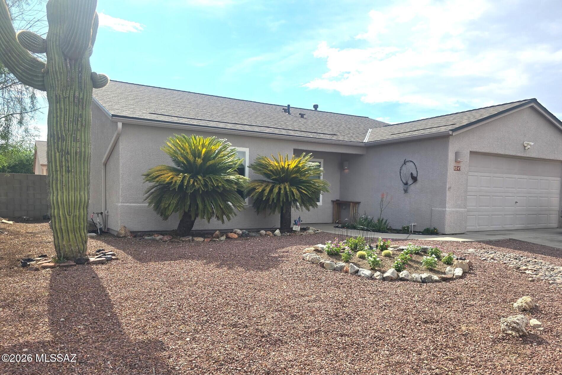 This well maintained 3 bedroom, 2 bath home offers a well thought out floorplan featuring a formal living room plus an open kitchen concept great room, plus a tandem 3 car garage! This home offers comfort and efficiency with paid off Solar. Updates include a new roof, windows, patio screens, gutters, water heater, and kitchen cabinets, all within the last two years. Great curb appeal with easy-care landscaping, sprinklers, desert plantings and a gorgeous saguaro cactus! You'll love life on your covered patio in the backyard with real grass and mountain view! Located in the highly desired Continental Reserve, near Tucson Mountain foothills, Safford (Sombrero) Peak, and Saguaro National Park! Conveniently near I-10, shopping, dining, schools, and medical. Enjoy Arizona living at it's best!