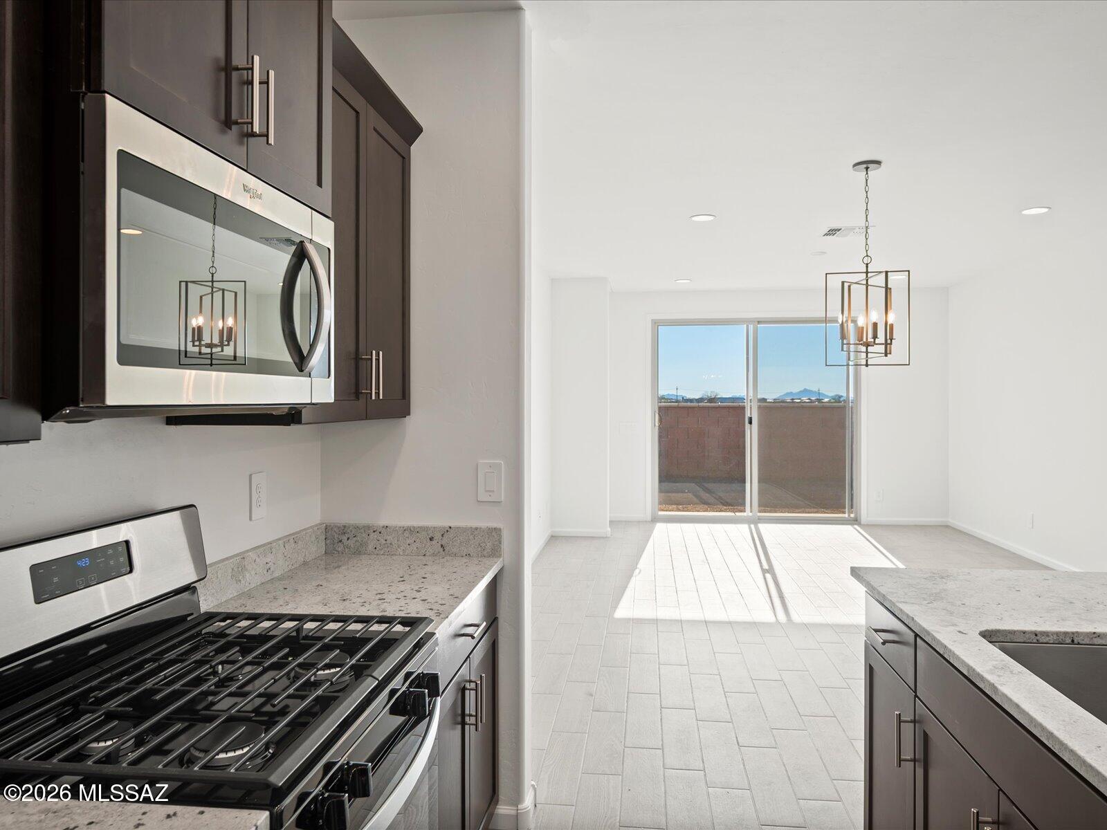 The Quartz floorplan in Tucson, Arizona offers an open concept layout with 3 bedrooms and 2 bathrooms. Umber cabinets with shaded grey granite countertops, wood-look tile flooring with multi-tone carpet in our Elemental package. Summerstone is now selling in Marana, Arizona. Conveniently located near the Continental Ranch area, this community offers access to both Marana and Northwest Tucson via the I-10. Residents can enjoy the outdoors at Saguaro National Park, El Rio Preserve, and the Summerstone community park. Move-in ready with a washer, dryer, fridge, and whole-home blinds.