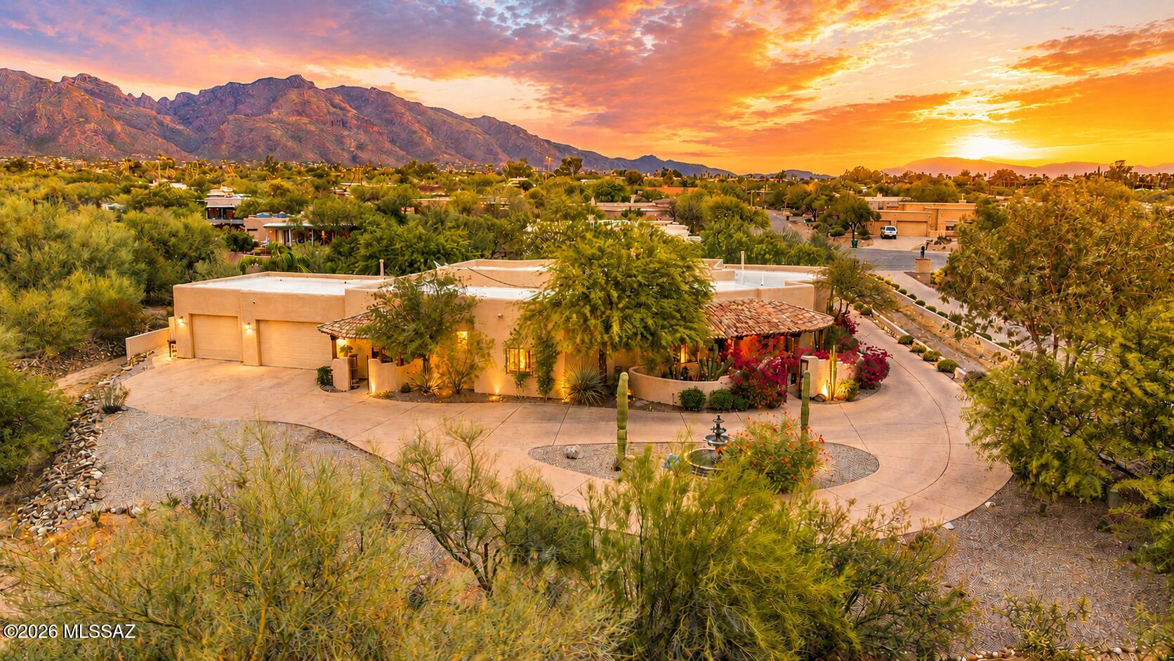 Welcome Home! Tucked away on a private drive amidst a canopy of mature trees and lush desert landscaping, this exceptional Casas Adobes residence offers a rare sense of privacy and tranquility while remaining moments from Tucson's finest dining, shopping, and everyday conveniences! Thoughtfully designed and meticulously maintained, this is a home where pride of ownership is evident at every turn!
From the moment you arrive, the home creates an immediate sense of arrival. Mature landscaping, inviting architecture, and a peaceful setting give way to interiors filled with soaring ceilings, generous proportions, and remarkable sightlines that draw your eye through the home and into the backyard beyond! Every space feels open, connected, and filled with natural light. Designed around a highly desirable split-bedroom floor plan, the layout offers exceptional flexibility for both everyday living and hosting guests. The expansive primary suite is a true retreat, while secondary bedrooms enjoy privacy of their own. Rich finishes, custom details, abundant storage, and oversized living spaces create a home that is as functional as it is beautiful!
At the heart of the residence, the chef's kitchen flows effortlessly into the great room and outdoor living spaces, making entertaining feel effortless. Large windows frame the surrounding landscape, creating a constant connection to the lush gardens and peaceful outdoor setting!
Step outside and discover your own private resort. The backyard has been lovingly cultivated into a secluded sanctuary, where mature trees, vibrant landscaping, and carefully designed outdoor spaces create an atmosphere rarely found in the desert Southwest. Lounge beside the sparkling pool, relax in the spa, enjoy evenings beneath the covered patio, or simply take in the sounds of birds and rustling trees. Every inch of the property has been thoughtfully cared for and designed to be enjoyed year-round!
Beyond its beauty, this home offers the confidence that comes with exceptional stewardship. Every system, finish, and landscape element reflects years of attentive maintenance and thoughtful ownership, providing a level of quality that discerning buyers immediately recognize!
Located in one of Tucson's most established and sought-after neighborhoods, this home combines timeless architecture, remarkable privacy, mature landscaping, and an effortless indoor-outdoor lifestyle into a rare offering. For the buyer seeking refined desert living without compromise, this is a residence that simply feels like home!