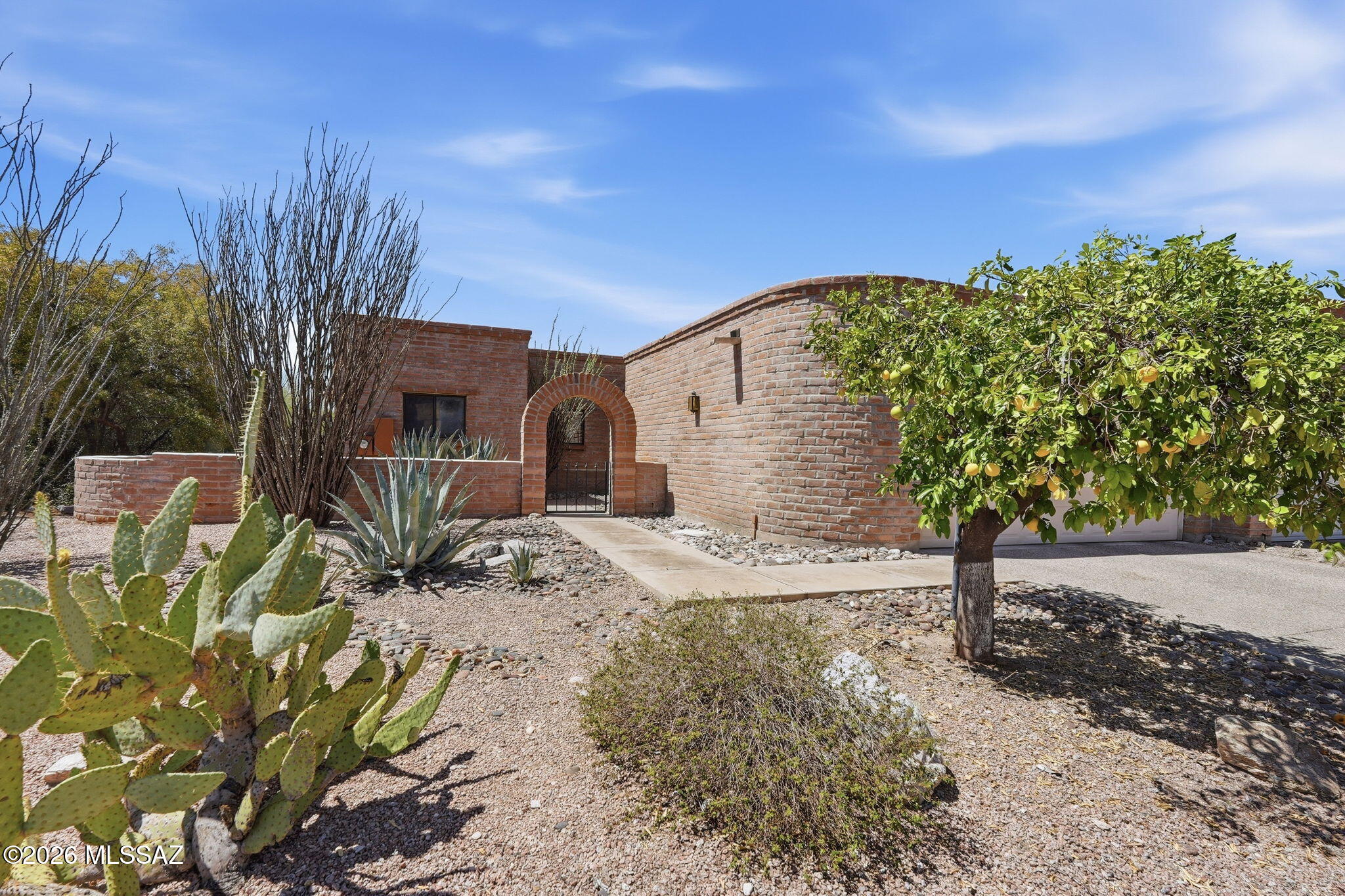 Charming burnt-adobe townhouse in the desirable Fairfield community showcasing stunning mountain, sunrise, and city views. This single-level 2BR/2BA home features a bright living room with beehive fireplace and skylights, plus a kitchen with breakfast nook and separate dining area. The spacious primary suite offers a generous walk-in closet and en-suite shower. The extended-length 2-car garage includes laundry and ample storage. Enjoy outdoor living with two covered patios, a private courtyard, fountain, and lush desert landscaping bordering common area. With access to the community pool and spa, this inviting Foothills retreat blends comfort, charm, and timeless Southwest appeal.