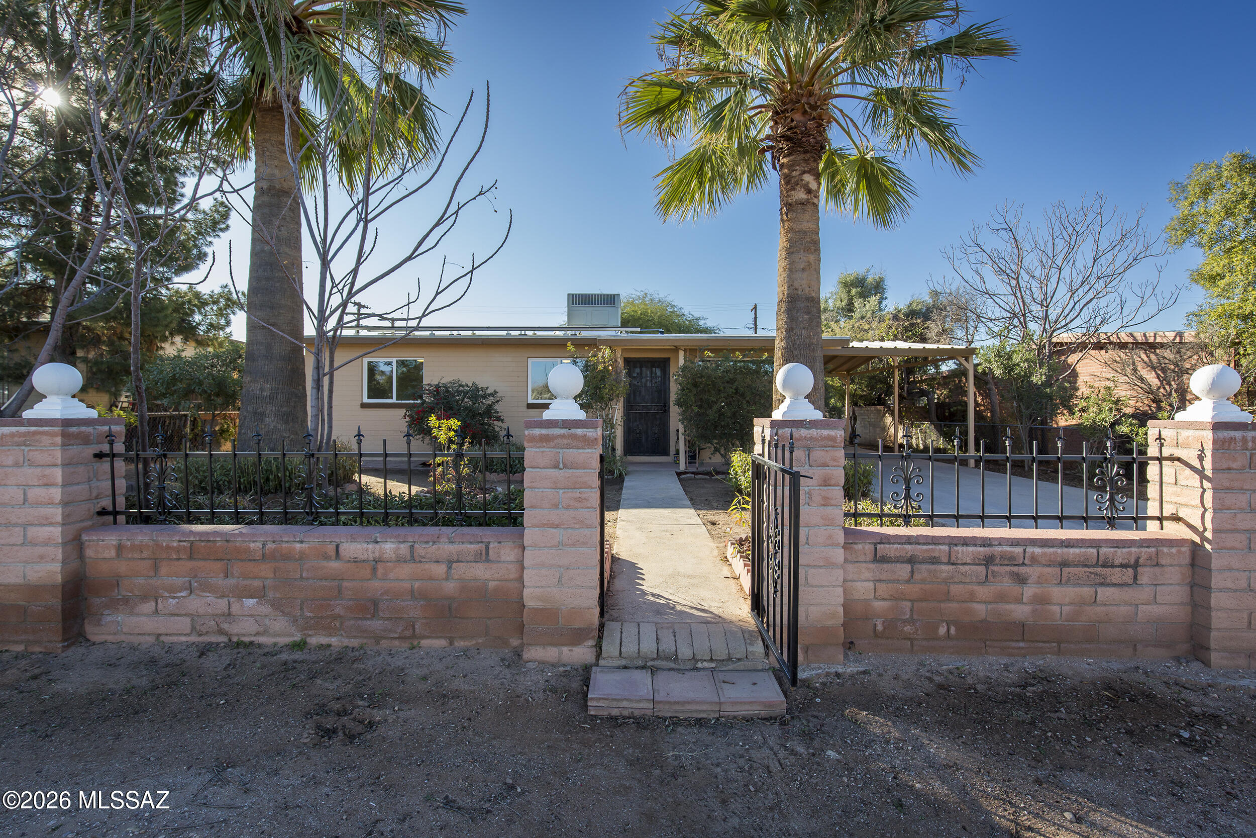 Move-in-ready, affordable home ideal for first-time buyers looking for low monthly costs and long-term value. A fully owned 27-panel solar system keeps electric bills exceptionally low, helping stabilize expenses from day one. The home is clean and finished, featuring ceramic tile throughout, recessed lighting, and ceiling fans in every room. The bright living room includes a large picture window, and the functional kitchen connects directly to the dining and laundry areas. The primary bedroom offers a private half bath. Dual-pane windows are installed throughout except the kitchen, with security doors in place. Mature shade trees and established landscaping provide natural cooling and privacy. Seller is a licensed real estate agent in AZ. Offers a rare combination of fully owned solar, extensive parking, and a large, usable lot with alley accessideal for buyers who value flexibility, sustainability, and long-term upside. The home includes a 27-panel fully owned solar system (no lease or payments), significantly reducing energy costs. Mature shade trees throughout the property help moderate summer heat naturally and enhance livability year-round. Inside, the home features ceramic tile throughout, recessed lighting, and ceiling fans in every room. The living room includes a large picture window, and the open kitchen connects directly to the dining area and dedicated laundry space. The primary bedroom offers a private half bath. Dual-pane windows are installed throughout the home except the kitchen, and security doors are in place. The oversized backyard provides exceptional opportunityample room for an addition, ADU, or both, with excellent access via a 12-foot steel double gate to a wide rear alley. The lot also offers plenty of space for future rainwater harvesting systems, expanded landscaping, or a true gardener's paradise. Parking is a major asset, with a 12x25 covered carport, room for vehicles parked back-to-back, and approximately 85 feet of existing paved parking including the carport, plus generous on- and off-street parking. Additional exterior features include a 14x5 covered front patio and an 8x12 shed with 8-foot ceilings. The property is landscaped with established, low-maintenance vegetation, including palms, citrus, pomegranate, mulberry, mesquite, guajillo, privet, and jujubeproviding shade, privacy, and long-term resilience.