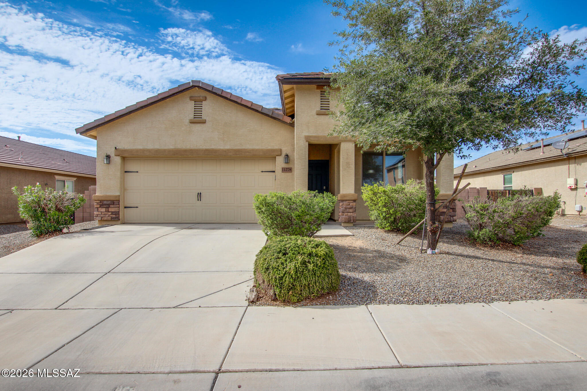 Beautiful & Move-In Ready in San Lucas! This exceptionally well-maintained, single-story contemporary home offers the perfect blend of modern comfort and convenience. Freshly painted throughout the interior, this home feels bright and brand new. Step inside to an inviting, open-concept great room layout featuring easy-care ceramic tile flooring throughout the main living areas and elegant dark wood-look laminate flooring in the formal dining space. The upgraded kitchen is a chef's delight, complete with gorgeous polished granite countertops, a classic white subway tile backsplash, a matching closet pantry, dark wood cabinetry, and a full suite of energy-efficient stainless steel appliances (including a gas range). The highly desirable split-bedroom floor plan ensures privacy, highlighted by a spacious primary suite featuring a large walk-in closet and an en-suite bathroom with a classic shower/tub combo. Two additional guest bedrooms offer ample closet space and share a clean, full hall bathroom. Positioned on one of the larger lots in the community, the expansive, fully block-fenced backyard offers a covered patio, lush artificial turf, low-care desert landscaping, and a built-in fire pit area--leaving plenty of room to create your dream outdoor oasis. Just minutes from I-10, local parks, and shopping, this Marana home is ready for its next chapter.