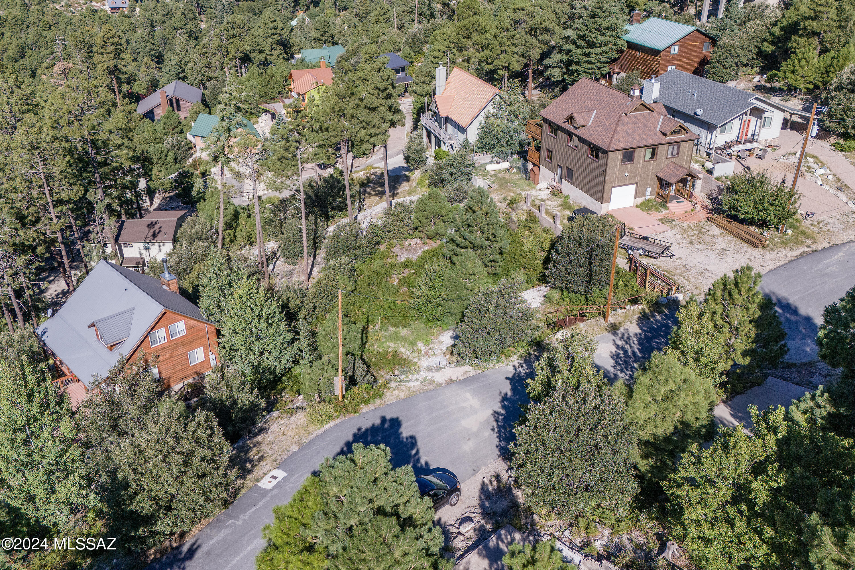 This special parcel of land, on Mt. Lemmon, is surrounded by mature trees and is located on a paved road, allowing for year-round access. It is situated in the heart of Summerhaven. Established homes nearby with water and electric at the road. The lot boasts views and is an ideal spot for your future cabin.
