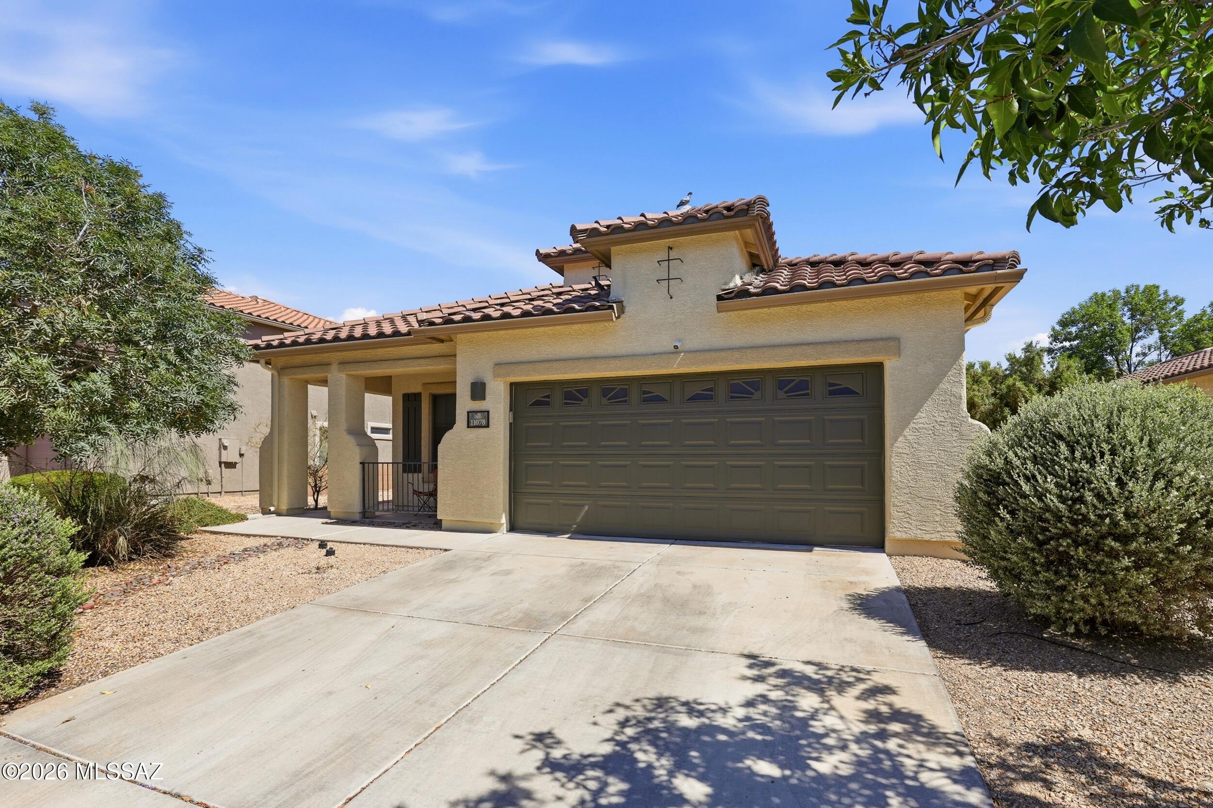 Potential Short Sale. Final terms subject to lender approval. Welcome to this beautifully maintained 3-bedroom, 2-bath home in the desirable Gladden Farms community of Marana. Offering 1,776 sq ft of thoughtfully designed living space, this single-story home features vaulted ceilings, abundant natural light, engineered wood flooring, and a functional split-bedroom floor plan. The spacious living room flows into the dining area and kitchen with ample cabinetry, pantry storage, breakfast nook, and refrigerator. The private primary suite includes a walk-in closet and dual vanities, while the covered patio and low-maintenance desert landscaping create the perfect outdoor retreat. Conveniently located near parks, schools, shopping, dining, and easy I-10 access.