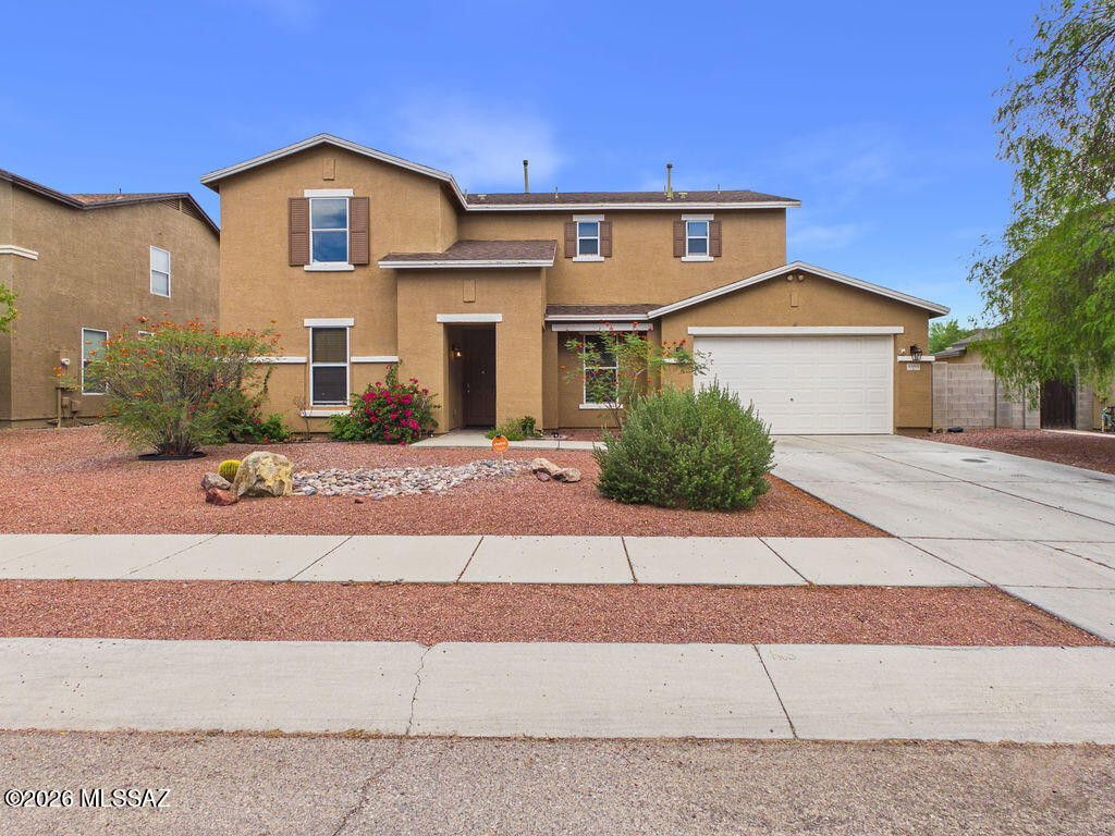 Welcome home to this spacious and versatile 4-bedroom, 3-bathroom residence offering 2,273 square feet of comfortable living space in the heart of Tucson's growing southwest side. Designed with both functionality and entertaining in mind, this two-story home features an open-concept floor plan with a bright kitchen overlooking the dining and living areas, creating the perfect gathering space for family and friends.

The well-appointed kitchen offers abundant cabinetry, generous counter space, a breakfast bar, and seamless flow into the main living area. A downstairs bedroom and full bathroom provide flexibility for guests, multigenerational living, or a private home office. Upstairs, you'll find a spacious loft ideal as a second living room, game room, media space, or homework area. The primary suite features a large ensuite bath with dual vanities and ample storage, while the additional bedrooms provide comfortable accommodations for family members or guests. Neutral finishes, tile flooring in high-traffic areas, and plentiful natural light create a warm and inviting atmosphere throughout.

Step outside to a generously sized backyard with an extended covered patio and expansive concrete entertaining area, offering endless possibilities for outdoor living, recreation, or future customization. The low-maintenance desert landscaping allows you to spend more time enjoying your home and less time maintaining it.

Conveniently located near schools, parks, shopping, dining, and easy access to major transportation routes, this move-in ready home offers the space, flexibility, and value today's buyers are looking for.