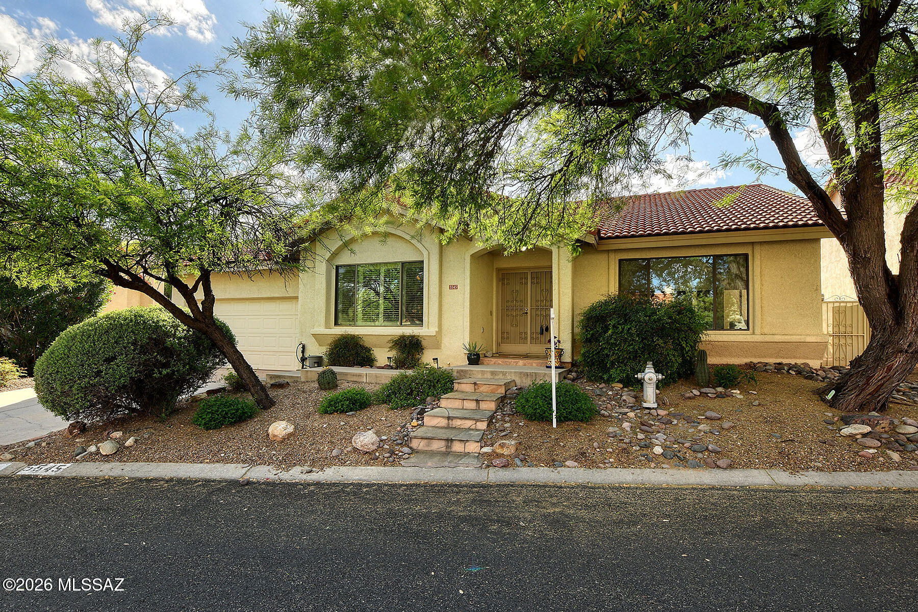 Desirable Sabino Canyon area community of single story homes in Catalina Foothills School District. Excellent split bedroom floorplan with high ceilings on one energy efficient level (2x6 construction). Wood and tile flooring. Custom wood trim and moldings for extra detail. Leaded glass clearstory window at dining room. Family room adjacent to kitchen has wood burning fireplace. French doors from kitchen out to inviting Saltillo tiled patio and spacious easy care yard. New HVAC + new Energy Star certified SS appliances. Walk in shower in master, Silestone counters, large walk-in built out closet. Bathrooms renovated by original prior owner. HOA includes front yard, road and community pool/spa maintenance. Easy access to Sabino Canyon Recreation area and plentiful nearby Shops/Restaurants. LA is related to seller.