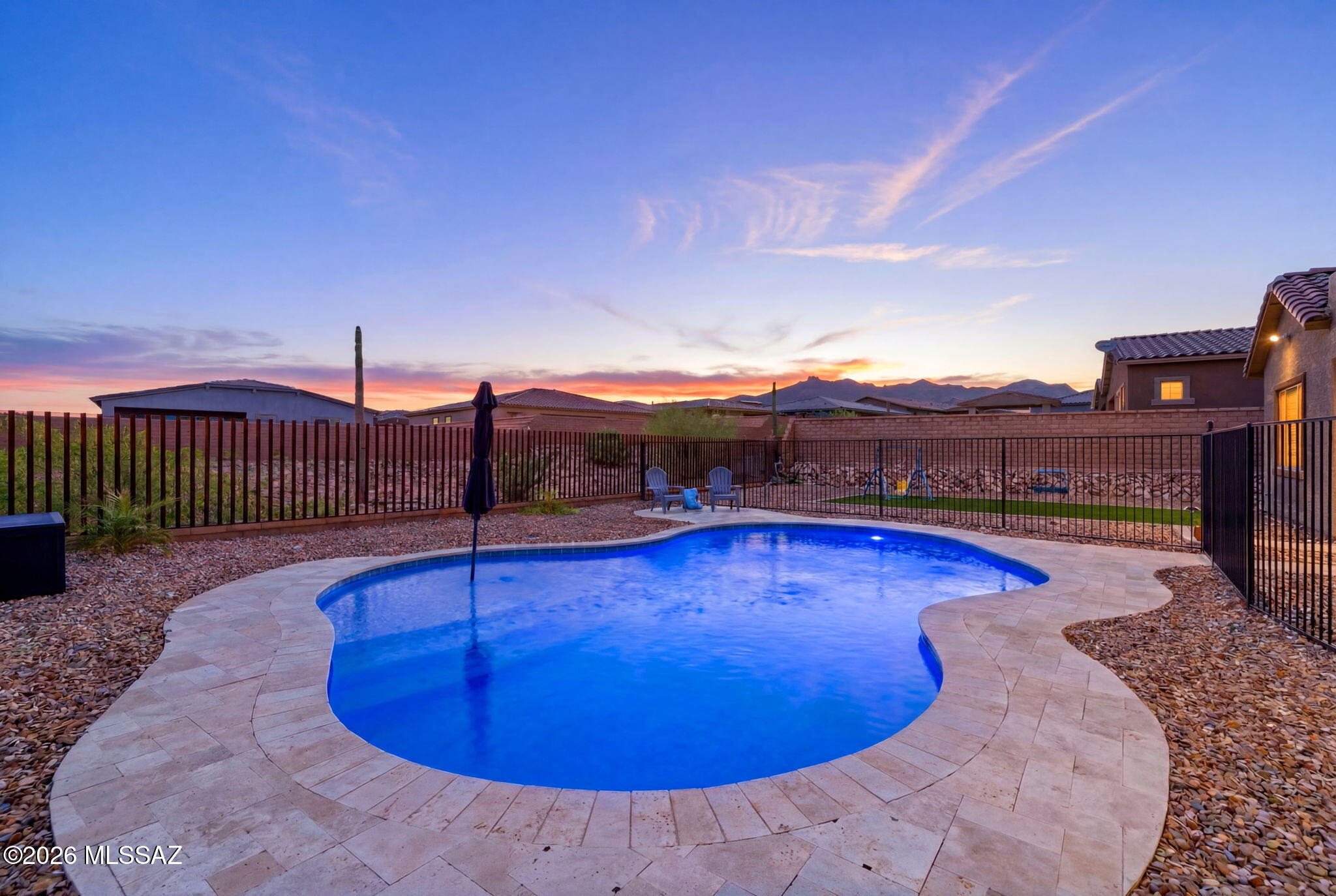 There is a particular kind of evening that happens here, when the sun drops behind the Tortolita Mountains and the sky turns gold to rose to blue, while you are still in the pool. That is the evening this home was built for. This 2023 Lennar Catalina C sits on a premium 0.27 acre homesite in gated Los Saguaros at Dove Mountain, now with a brand new freeform pool and travertine decking as the showstopper. Inside, an open Great Room flows to a kitchen with granite counters, gas cooktop, and walk in pantry. Split floor plan, spa inspired owner's suite, dual walk in closets, flex den. Smart home features throughout. Gated community with clubhouse, park, and trails. Move in ready. There is a particular kind of evening that happens in Dove Mountain, when the sun drops behind the Tortolita Mountains and the sky turns from gold to rose to deep blue, all while you are still in the pool. That is the evening this home was built for.

Set on a premium 0.27 acre homesite in the gated community of Los Saguaros at Dove Mountain, 6510 W Antler Bend Place has just added the one feature every buyer wants and few listings actually have: a brand new pool, freeform in shape with a soft pebble finish and travertine decking Throughout the backyard. A turfed side yard rounds out the space, giving kids or pets somewhere to run while the adults enjoy the view. An extended covered patio complete a backyard built for actual living, not just looking at.

Inside, the 2,598 square foot Catalina C floor plan by Lennar lives like new because it practically is, completed in 2024. An open Great Room connects to a kitchen built for real cooking and real gathering, with granite counters, a gas cooktop, stainless appliances, a walk in pantry, and a generous center island that overlooks the dining area and covered patio beyond. The split bedroom design places two secondary bedrooms and a flexible den away from the owner's suite, which offers a spa inspired bath with dual vanities and dual walk in closets, a true retreat at the end of the day.

Smart home touches come standard throughout: a Honeywell Z-Wave thermostat, smart front door lock, along with a tankless water heater for efficiency and comfort in every season.

Los Saguaros at Dove Mountain offers gated privacy, a community clubhouse, a park, and walking trails, all just minutes from Dove Mountain's golf courses and the growing shops and restaurants of Marana. This is move in ready living with the one upgrade that changes everything: your own resort just outside the back door.