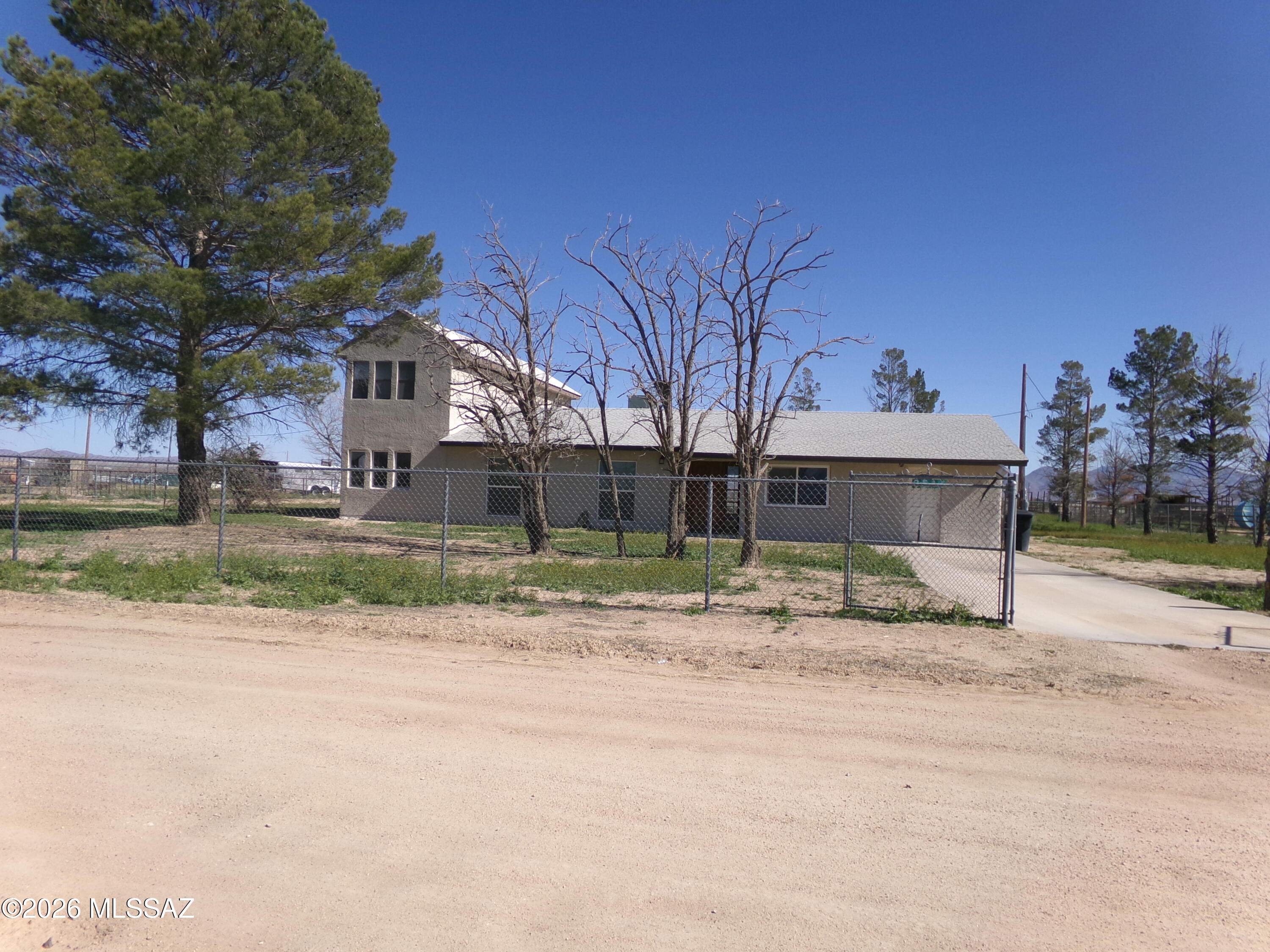Two story home on 2.41 acres. Spacious 4 bedroom 4 bathroom home with den & office. Family room connects to a formal dining area off the kitchen. Kitchen has granite counter top and lots of cabinet space. Master bedroom has a large walk-in closet.  Each bedroom has its own bathroom.  Covered patio with a laundry room to the North.  Second floor has 3 rooms  and could be used as guest quarters.  A well maintained home. 
Owner is a licensed  Real Estate Agent in Arizona.