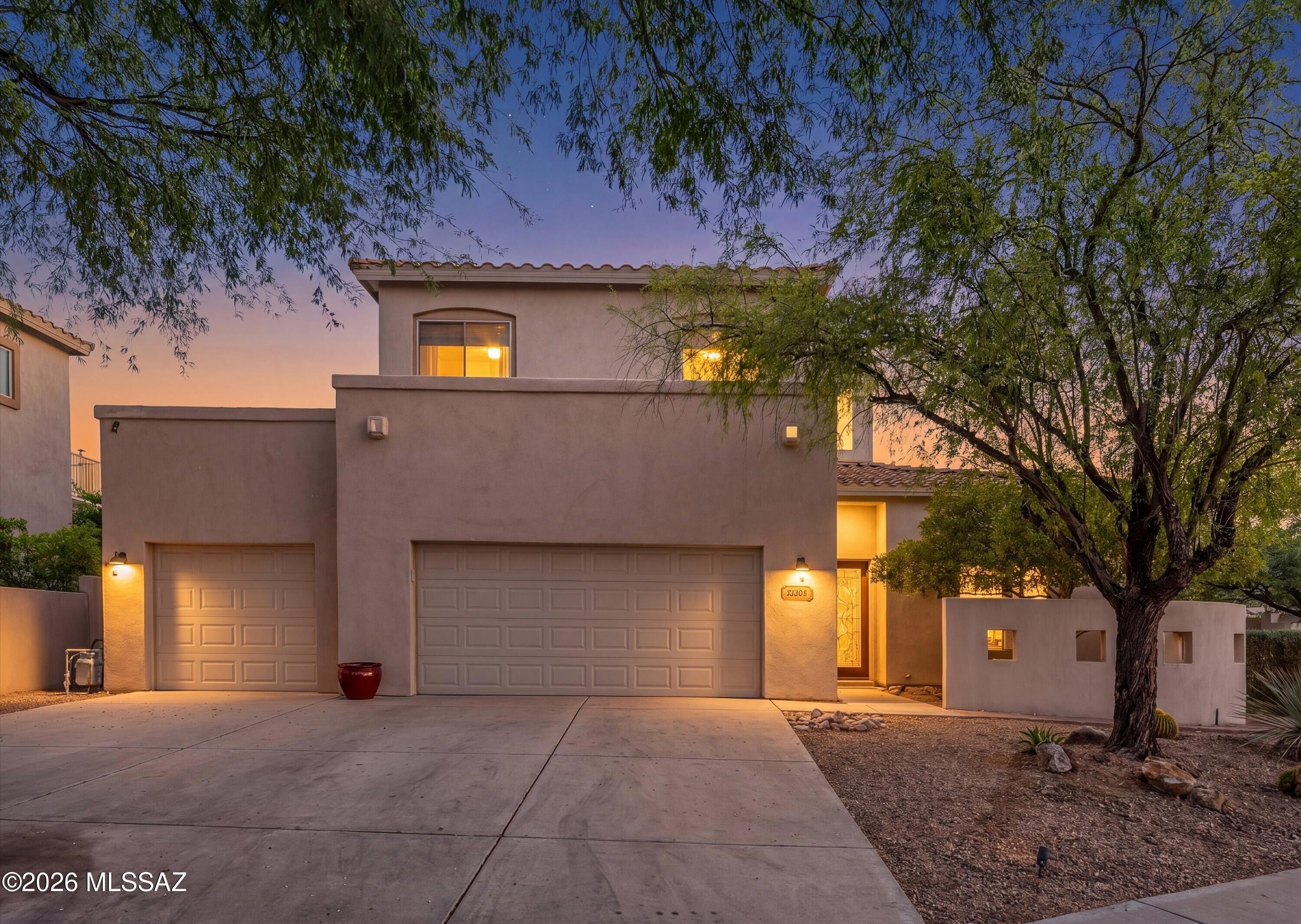Exceptional 5BR/3BA Rancho Vistoso estate presented by Oro Valley's premier luxury brokerage. Soaring ceilings, a dramatic curved staircase, a beautifully renovated chef's kitchen, a custom reclaimed wood fireplace wall, newer flooring throughout and breathtaking Catalina Mountain views combine to create a truly exceptional offering. The spacious 21x16 primary suite features a beautifully updated spa-inspired bath and private view deck, while the backyard delivers a resort-style experience complete with a pool, spa, slide, fire pit and multiple outdoor living spaces.
Beyond the impressive architecture lies a home thoughtfully transformed for today's luxury buyer. The recently renovated chef's kitchen serves as the centerpiece of the home, anchored by an oversized natural stone island with seating, extensive white shaker cabinetry, a farmhouse apron sink, built-in wine refrigerator, built-in microwave and wall oven, gas cooktop with stainless vent hood, marble-inspired backsplash, designer lighting and abundant prep and storage space. The kitchen flows seamlessly into the family room and breakfast nook, creating an ideal setting for everyday living and entertaining.
The family room is anchored by a striking custom fireplace feature wall with built-in display niches and offers a warm, inviting space to gather. Just beyond, the breakfast nook captures beautiful Catalina Mountain views, while the separate formal dining room provides an elegant setting for holidays, dinner parties, and special occasions.
The impressive living room welcomes guests with soaring ceilings, tray ceiling accents, abundant natural light, and a dramatic curved staircase that creates a striking architectural focal point. Combined with the separate family room, formal dining room, and breakfast nook, these thoughtfully designed spaces offer exceptional flexibility for both intimate gatherings and grand-scale entertaining. .
Upstairs, the primary retreat delivers the private escape every homeowner deserves. Step onto your expansive private view deck and take in sweeping Catalina Mountain views before retreating to a beautifully updated spa-inspired bathroom featuring a freestanding soaking tub, spacious walk-in shower with designer tile finishes, frameless glass enclosure, dual vanities, elegant fixtures, and luxury finishes throughout. The thoughtfully designed floorplan also includes four additional bedrooms, highlighted by a desirable main-level guest suite arrangement with a full bathroom nearby, providing exceptional flexibility for guests, multigenerational living, or a private home office. 
The backyard rivals many luxury resorts, offering a sparkling pool and spa with waterfall and slide, expansive covered patio, fire pit gathering area, mature landscaping, and multiple spaces to relax, entertain, and enjoy Arizona's spectacular sunsets. Whether hosting family and friends or enjoying a quiet evening under the stars, this outdoor environment was designed to be experienced.
Located within the highly sought-after Rancho Vistoso community, residents enjoy convenient access to parks, walking and biking trails, golf, shopping, dining, and Amphitheater District schools. Combining exceptional upgrades, mountain views, resort-style amenities, and one of Oro Valley's most desirable locations, this is a rare opportunity to own a truly move-in-ready luxury home.