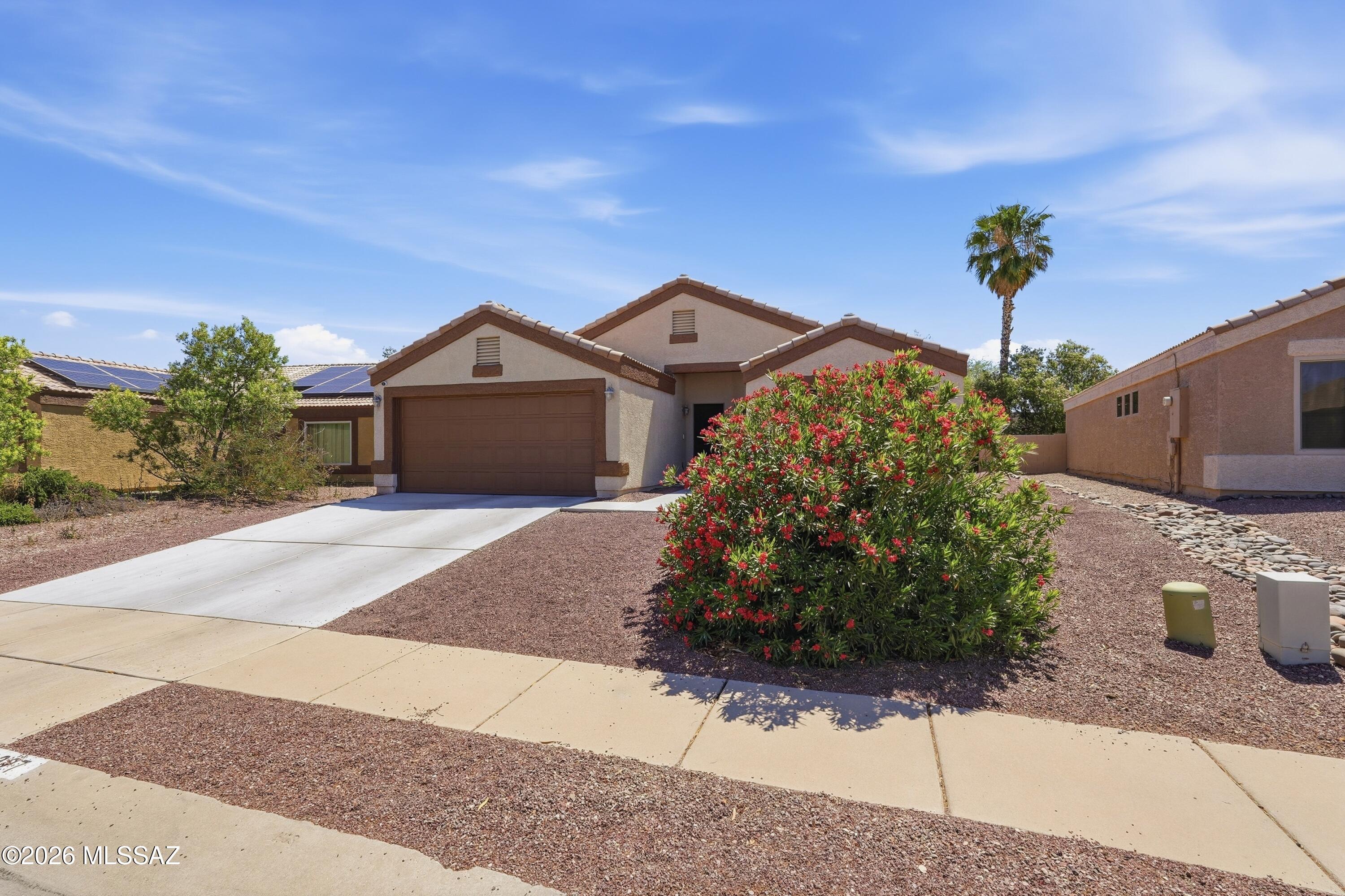 High Vaulted Ceilings.  Newer AC, Rita Ranch in Vail School District.  Conveniently located - to Frys, Near shopping, parks and schools.  Roomy easy-care yard with covered patio.  Spacious 2 car garage.  All solid wood flooring throughout.  Costco to open soon.