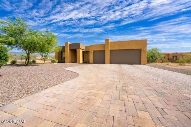 Former Model Home in the highly desirable Tanque Verde Valley! This exceptional 2,894 sq. ft. residence offers breathtaking mountain views, 4 bedrooms, 2 full baths, an upgraded designer powder room with floor-to-ceiling tile, and a versatile flex room. Filled with natural light, the open-concept layout features soaring ceilings, granite countertops, stainless steel appliances, upgraded flooring, and Hunter Douglas motorized shades. The chef-inspired kitchen flows seamlessly into the great room, perfect for entertaining. Enjoy a beautifully landscaped backyard with covered patio and stunning Arizona sunsets. Additional highlights include a 3-car epoxy-floor garage, water softener, reverse osmosis system, dual-pane windows, and low-maintenance irrigation. A rare opportunity in Bear Canyon!! stainless steel appliances, upgraded flooring, Hunter Douglas motorized shades, and numerous former model home enhancements.

The stunning powder room serves as a true statement piece, featuring floor-to-ceiling designer tile work that elevates the space with sophistication and style. The private primary suite provides a peaceful retreat, while the flexible layout offers endless possibilities for a home office, fitness room, media room, or guest accommodations.

Step outside to a beautifully landscaped backyard with covered patio and spectacular mountain views, providing the perfect backdrop for Arizona sunsets. Additional highlights include a 3-car garage with epoxy flooring, water softener, reverse osmosis system, dual-pane windows, and low-maintenance irrigation.

Rarely does a home of this caliber, quality, and location become available in one of Tucson's most desirable communities.