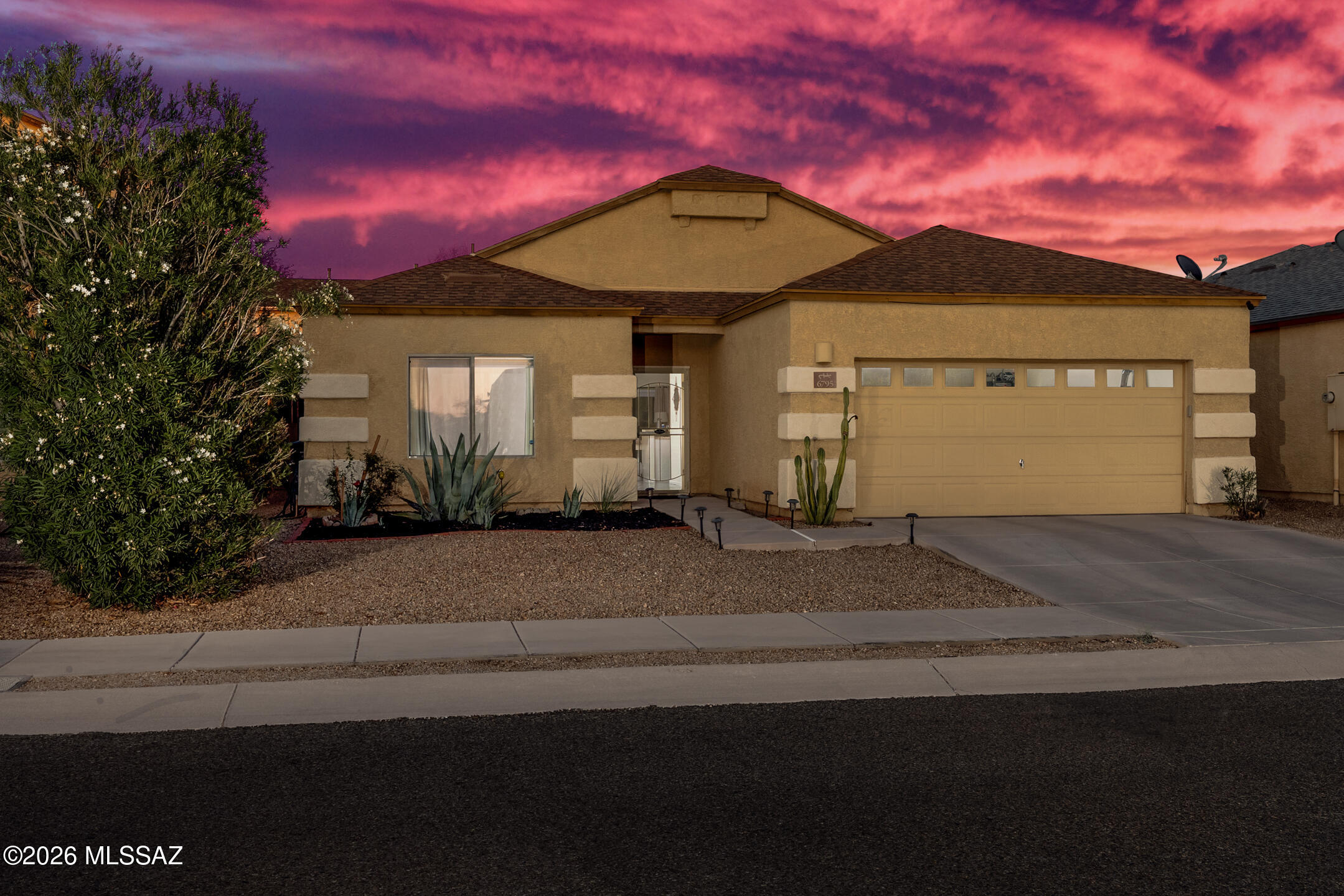 Welcome to this beautifully maintained contemporary home in the desirable Corazon Del Pueblo community! Built in 2006, this move-in ready 3-bedroom, 2-bath residence offers 1,527 sq. ft. of thoughtfully designed living space with an open-concept layout ideal for both everyday living and entertaining. The spacious kitchen features granite countertops, white cabinetry, stainless steel appliances, subway tile backsplash, pantry storage, and an oversized breakfast bar overlooking the living and dining areas. Elegant oversized tile flooring flows throughout the home, creating a clean and modern feel. The split-bedroom floor plan provides added privacy, while the generous primary suite offers a large walk-in closet, dual sinks, and a bright ensuite bath. Additional highlights include a dedicated laundry room, ample storage, and an oversized 2-car garage. Enjoy low-maintenance desert landscaping, a covered patio, and peaceful outdoor space perfect for relaxing Arizona evenings. Conveniently located near parks, schools, shopping, dining, DMAFB, Raytheon, and easy I-10 access. Your next chapter starts here!