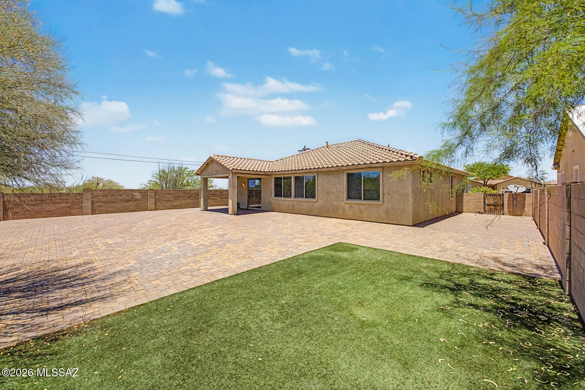 Tucked away at the end of a quiet cul-de-sac in a desirable gated community in Corona de Tucson and located within the highly sought-after Vail School District, this beautifully maintained Lennar home is the perfect blend of comfort and style. The popular split-bedroom floor plan offers privacy, while the spacious primary suite features a relaxing soaking tub, separate shower, and generous layout. The kitchen shines with granite countertops, rich maple cabinetry, and brand-new slate appliances. Additional upgrades include a newer water heater, fresh interior paint, and ceiling fans throughout. Step outside to a private, pool-sized backyard complete with pavers,