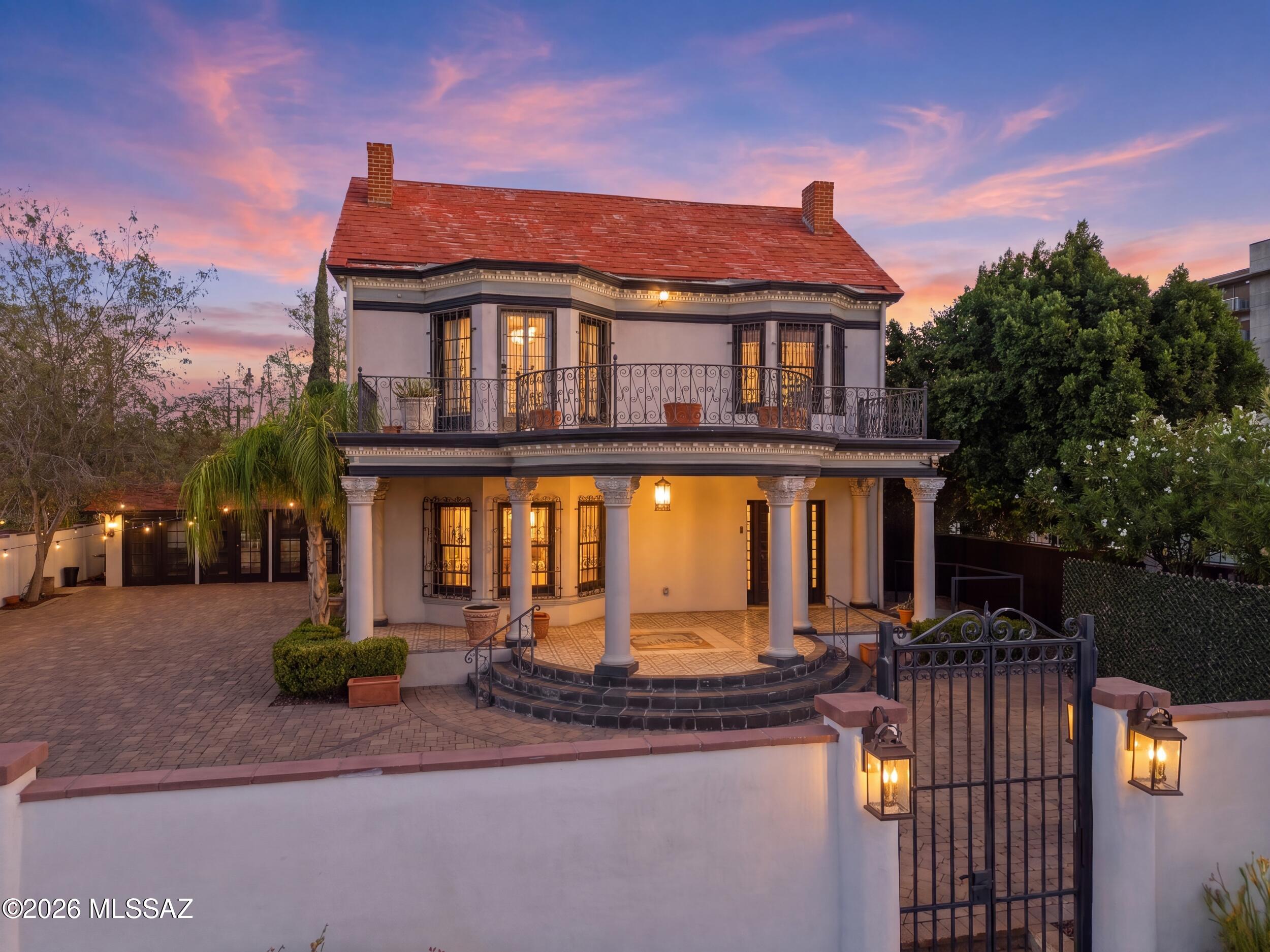 The Rubi Mansion--arguably one of Downtown Tucson's most iconic historic residences--stands proudly in the heart of Tucson's vibrant Commercial and Infill District, directly across from Armory Park. Built in 1907 for Senator Owen T. Rouse, this extraordinary property has been thoughtfully restored-preserving the craftsmanship and character that define its rich history while seamlessly blending modern comfort.
Throughout the home, original architectural details remain beautifully intact, including the original doors, intricate moldings, hardwood floors, grand wood staircase and banisters, built-in cabinetry, hand-painted concrete tile, and the original City of Tucson Seal showcased on the front porch.
On the main level, a grand entry foyer welcomes guests and flows... See more into elegant formal living and dining rooms, each anchored by a historic fireplace. A spacious family room and thoughtfully updated kitchen which is perfect provide comfortable everyday living while honoring the home's timeless character.
The second-floor features four spacious bedrooms, two of which have access to original wrought-iron balconies, along with two beautifully appointed bathrooms.
Completing the property is the carriage house, offering exceptional flexibility as a guest suite, artist's studio, private office, or creative workspace. Rich in history, architectural significance, and endless possibilities, The Rubi Mansion has served as a distinguished private residence, an art museum, and a venue for countless memorable gatherings. Today, it presents a rare opportunity to own one of Tucson's most celebrated landmarks and write the next chapter in its remarkable story.