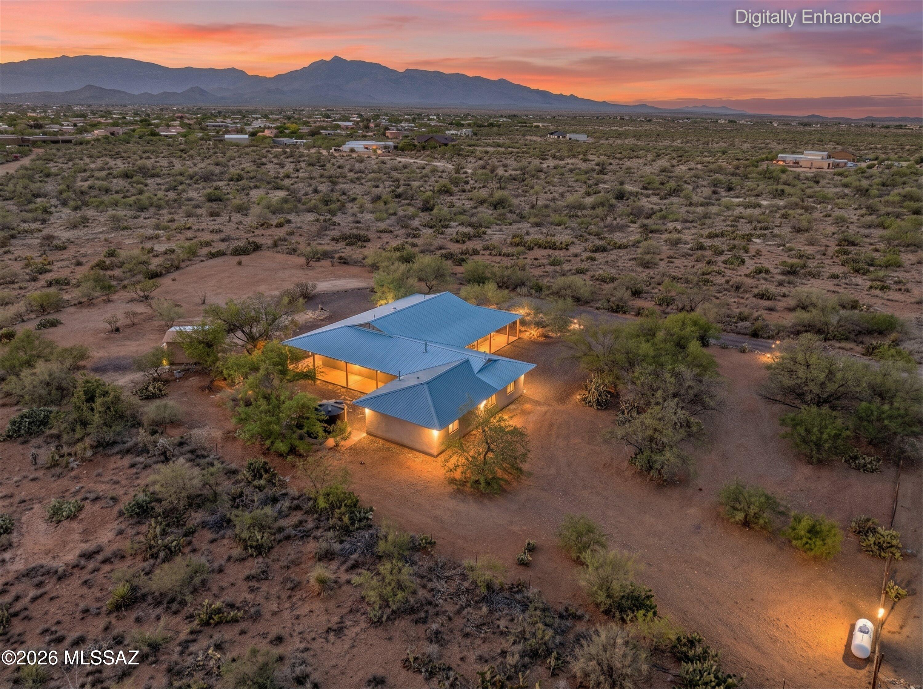 Stunning Custom-Built Home on 1.05 acres with 2-master suites and located in the extremely desirable Vail area. Enter this beautiful 3-bedroom plus office which can be easily converted to the 4-bedroom and you will find an open floor plan with amazing mountain views. Upgrades include concrete flooring, 10-ft ceilings, custom cherrywood cabinetry, 2x8 construction, and a private In-Law suite which includes its own living room, bedroom, & bath. The huge 1260 square foot wrap around covered porch is so delightful and perfect for all your entertaining. The property is fully fenced with a gated entrance to the property. This house is in the sought-after Vail School District. Just minutes from shopping, schools and I-10. This fabulous property is waiting for you!
