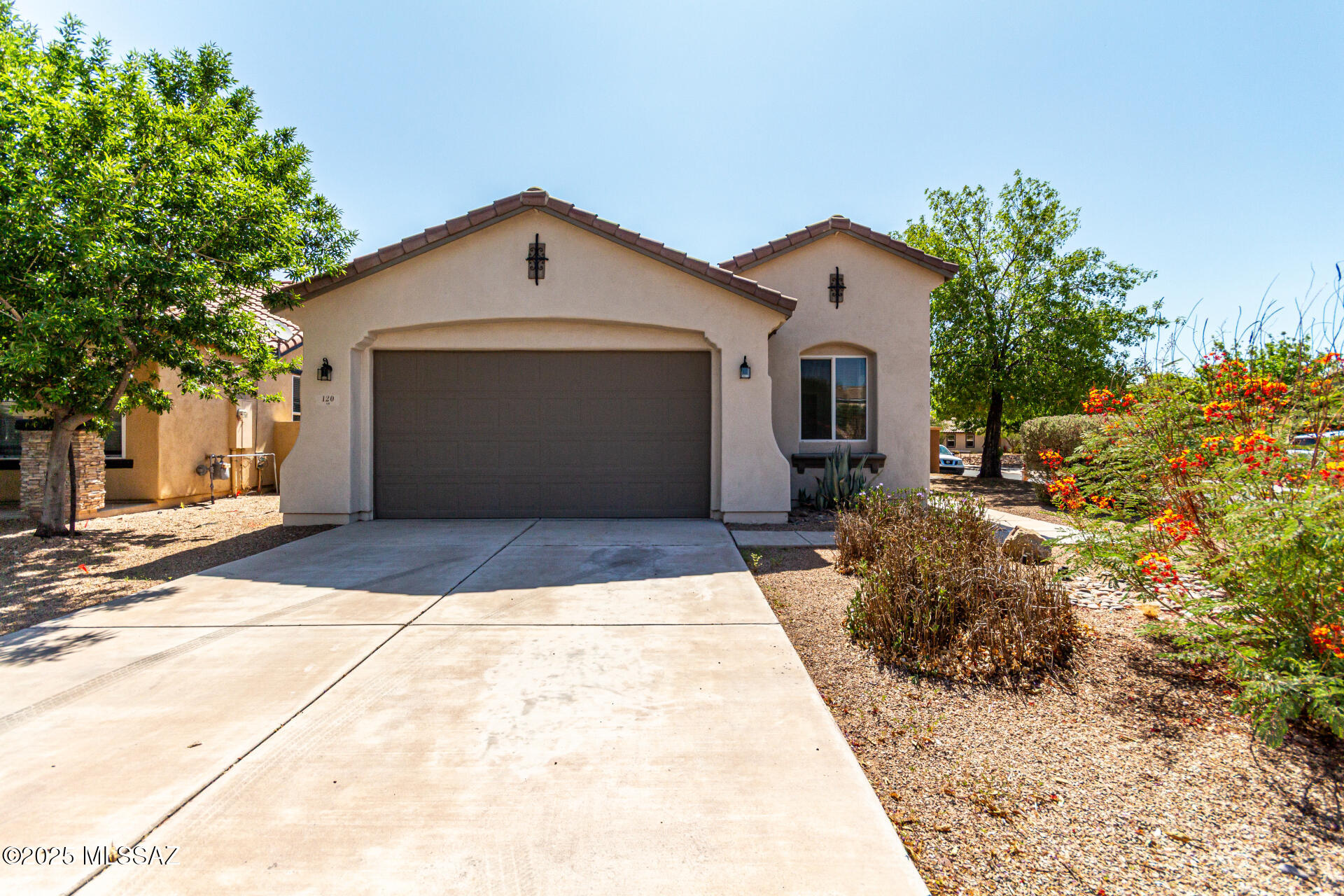 Fabulous corner lot home with no neighbors behind looking for a new owner! Sweet curb appeal, colorful desert plantings, & 2-car garage are just the beginning. Come inside to be delighted by the ample living room with endless entertainment potential & the nice-sized den ideal for an office. Cook delicious meals in the eat-in kitchen equipped with stainless steel appliances, granite counters complimenting the wood cabinets, & a pantry. Discover a bright main bedroom featuring an ensuite with a separate tub/shower, dual sinks, & a walk-in closet. Spend relaxing evenings after a hard day's work in the backyard comprising a covered patio with extended pavers, desert plantings, & play space. Don't let this great opportunity slip by! Act now!